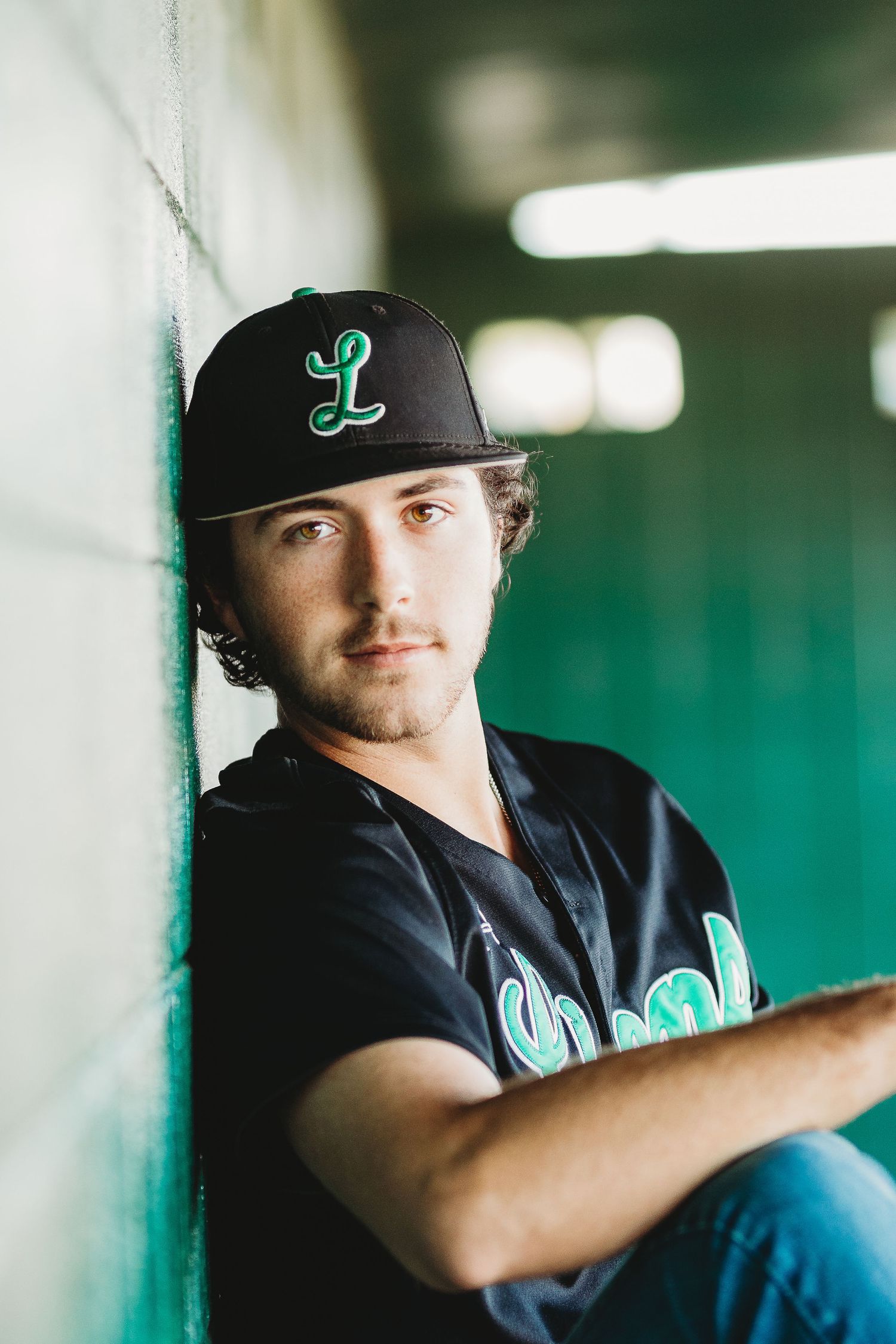 Sports-themed portrait series showing someone in a black baseball cap against a green background.