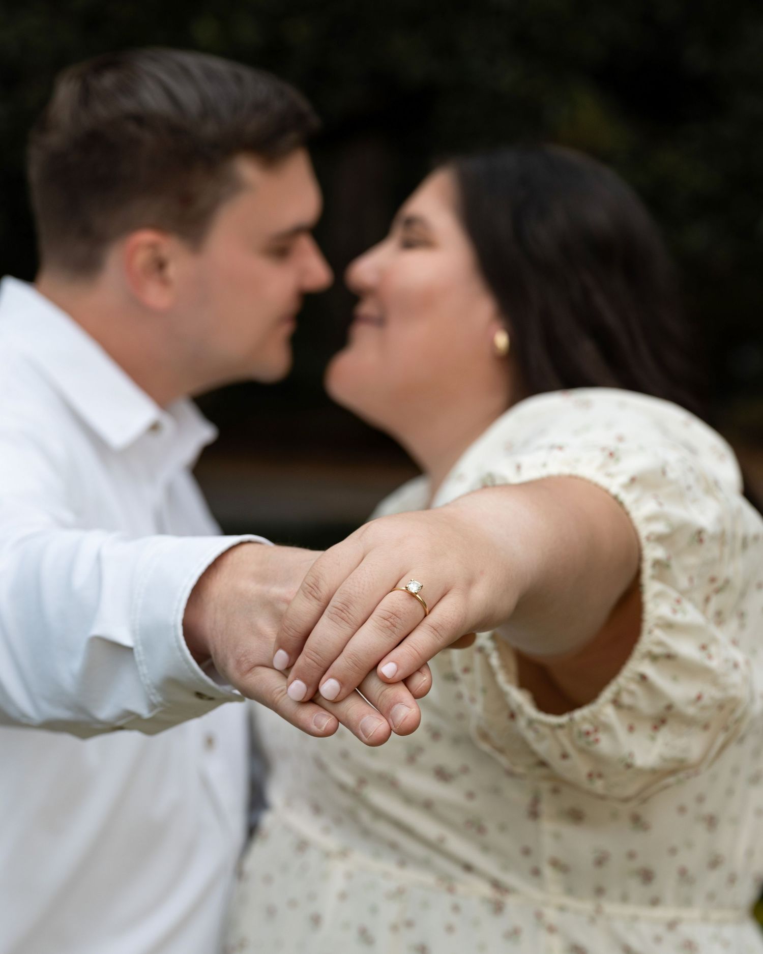 A romantic wedding photo sequence showing close-up shots of hands with rings and a tender kiss against a dark background.