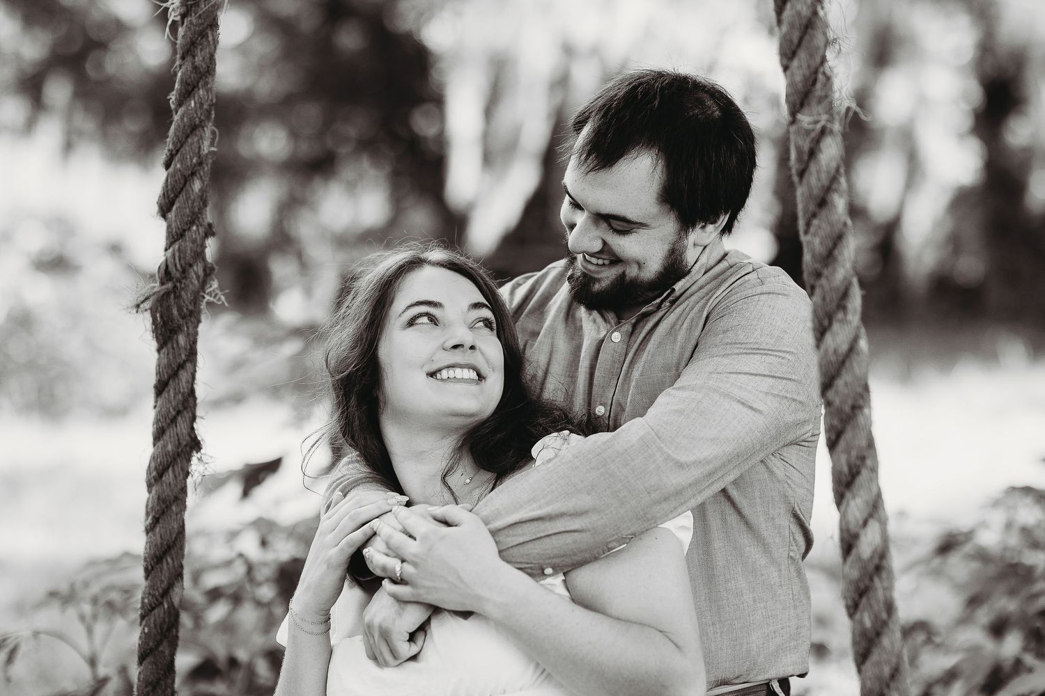 Black and white engagement photos showing tender moments between couple.