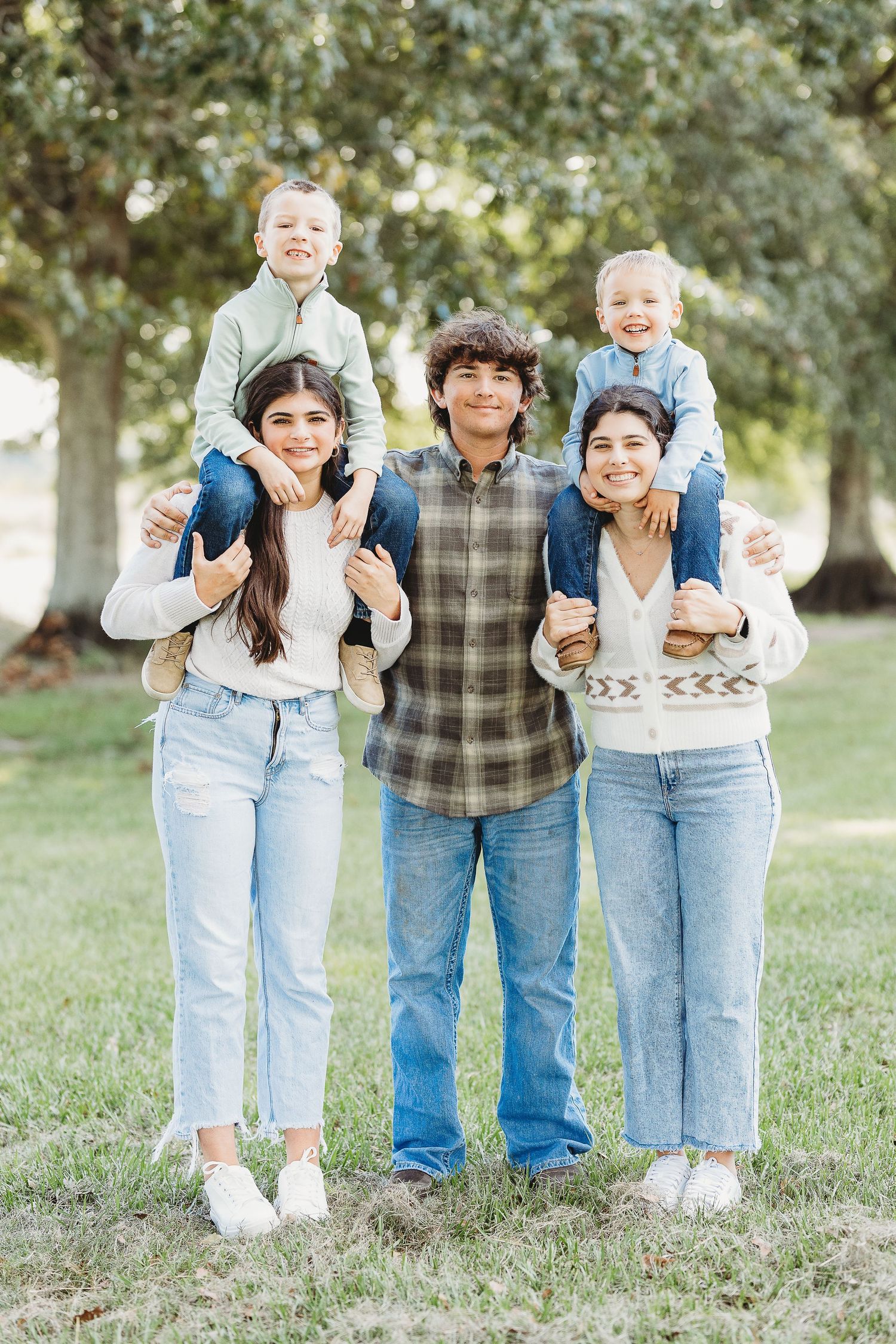 Candid family photo series showing joyful expressions in a park setting.