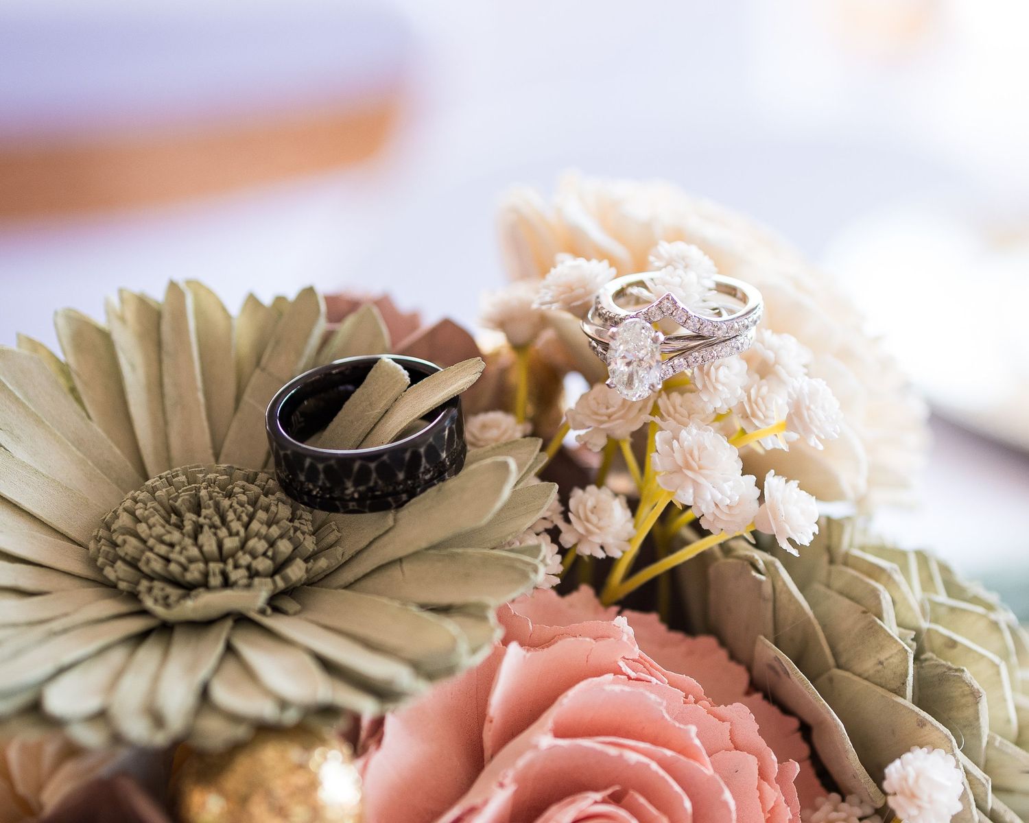 Delicate pink roses and cream gerbera daisies arranged in a romantic floral composition.