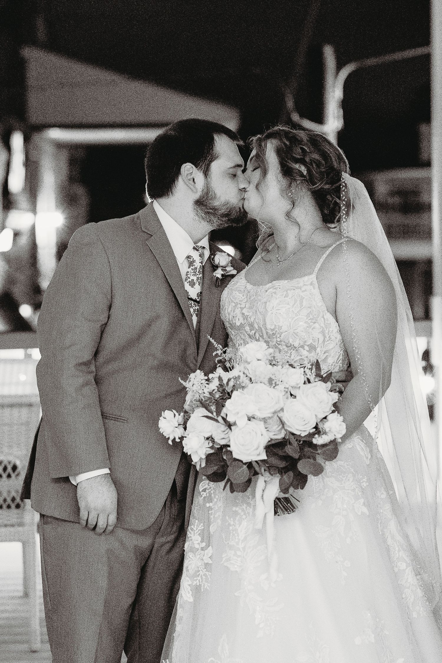 A tender black and white wedding photo captures intimate moments between the newlyweds.