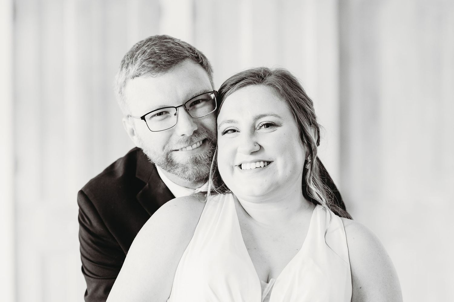 Emotional wedding moment captured in black and white with soft lighting.