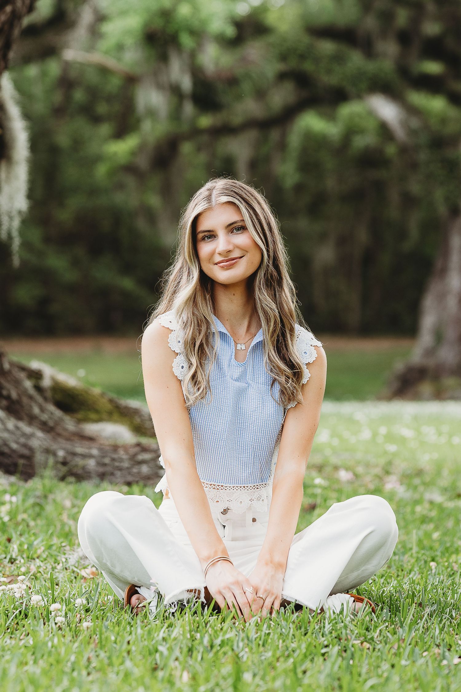 Casual outdoor photo series showing someone sitting in white pants on grass with trees in background.