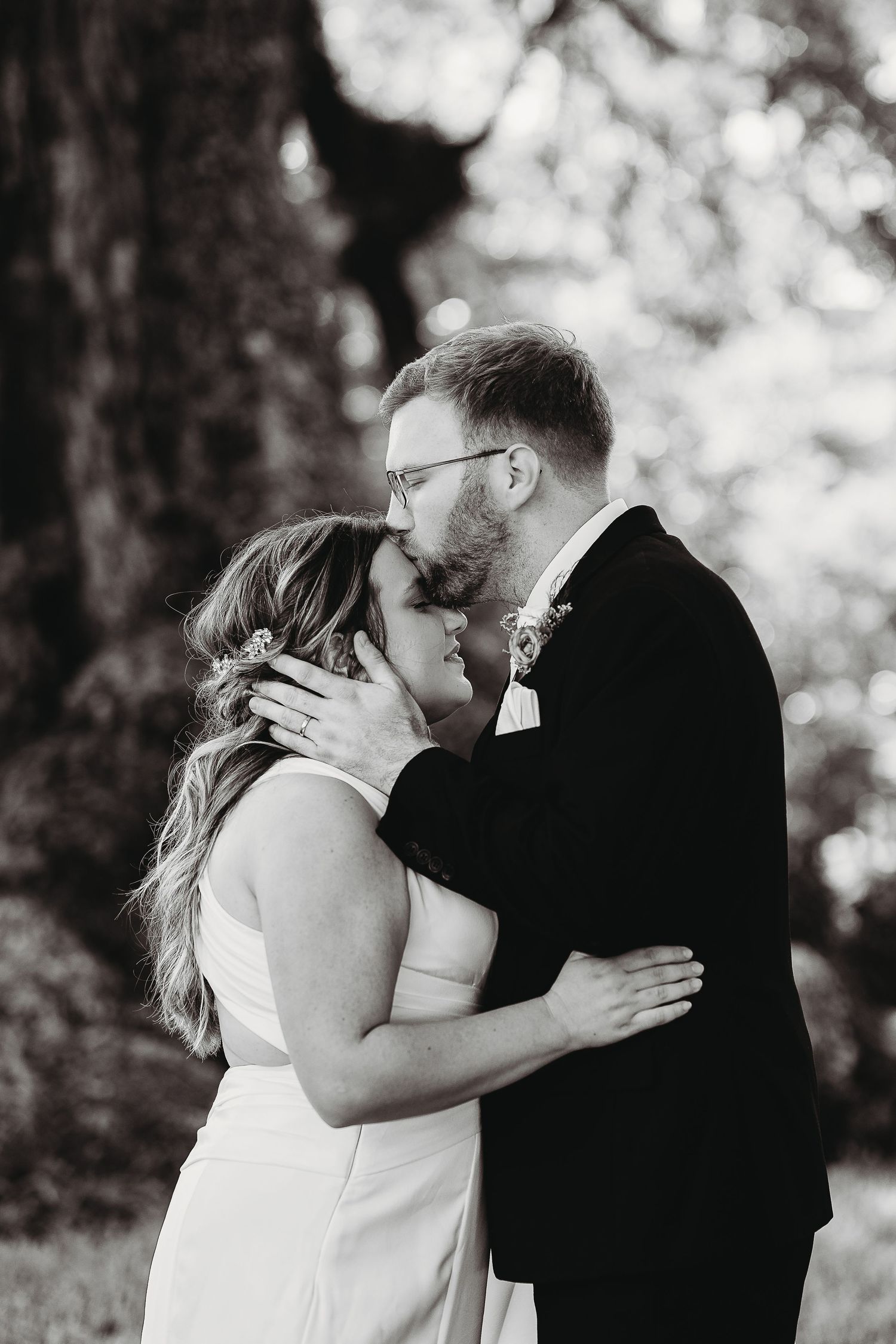 Black and white series of romantic wedding moments under natural outdoor lighting.