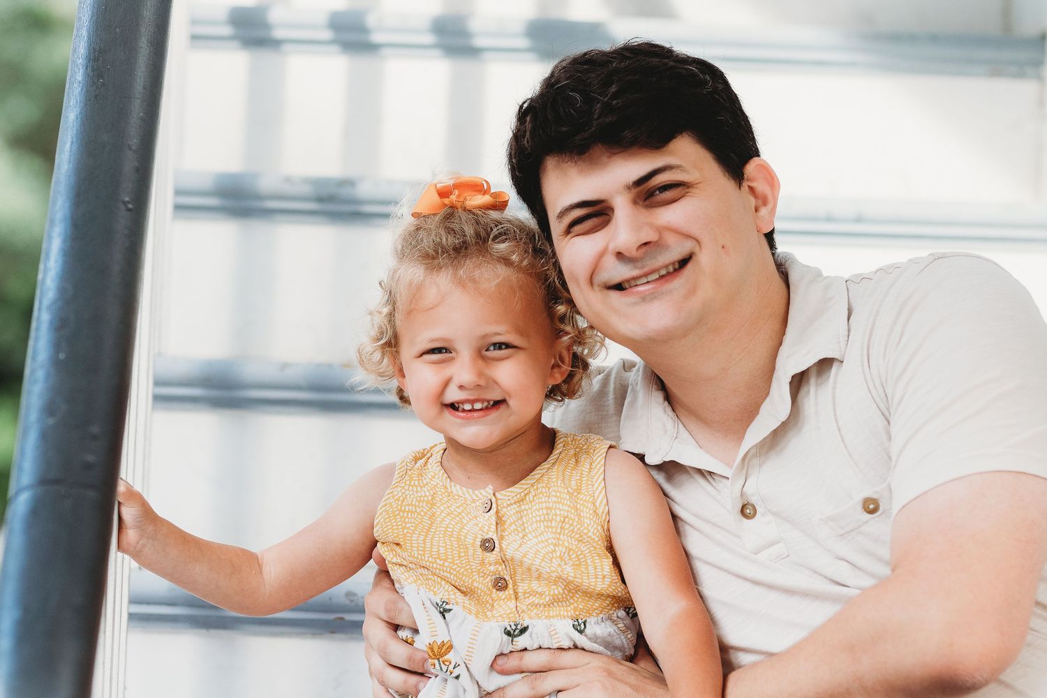 A joyful moment captured between parent and child on stairs.