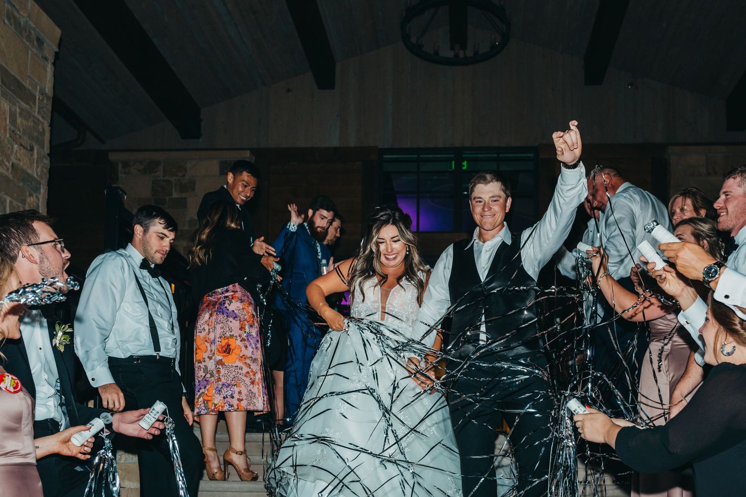 Wedding reception dance floor filled with guests celebrating in formal wear.