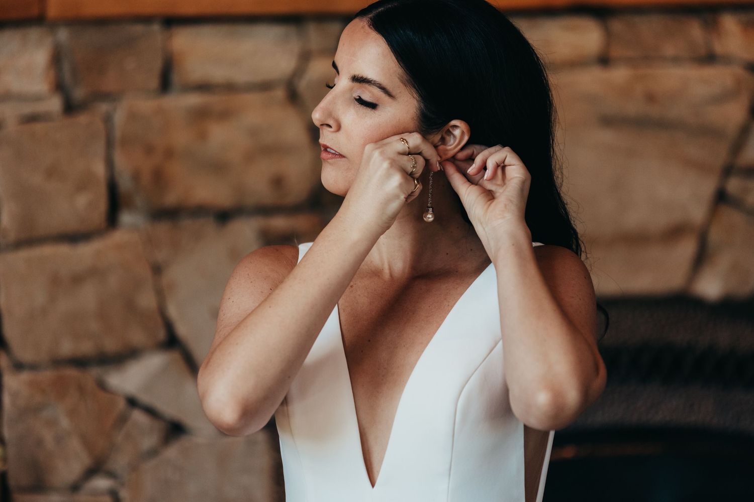 Side profile view of minimalist bridal styling and pearl earrings.