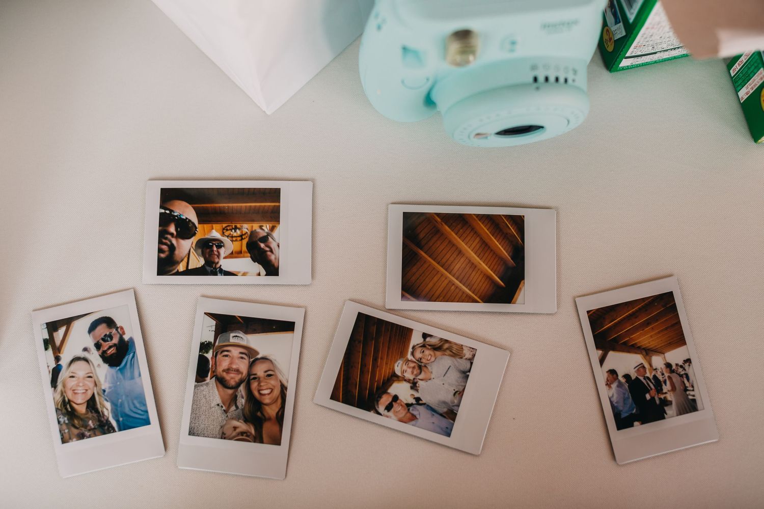 Collection of vintage-style polaroid wedding photos displayed on a white surface.
