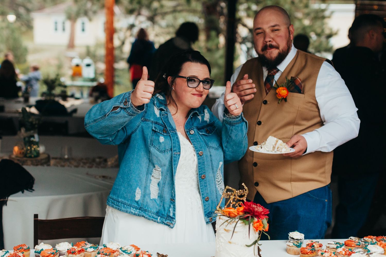 Joyful celebration at a wedding reception with casual attire and fall decorations.