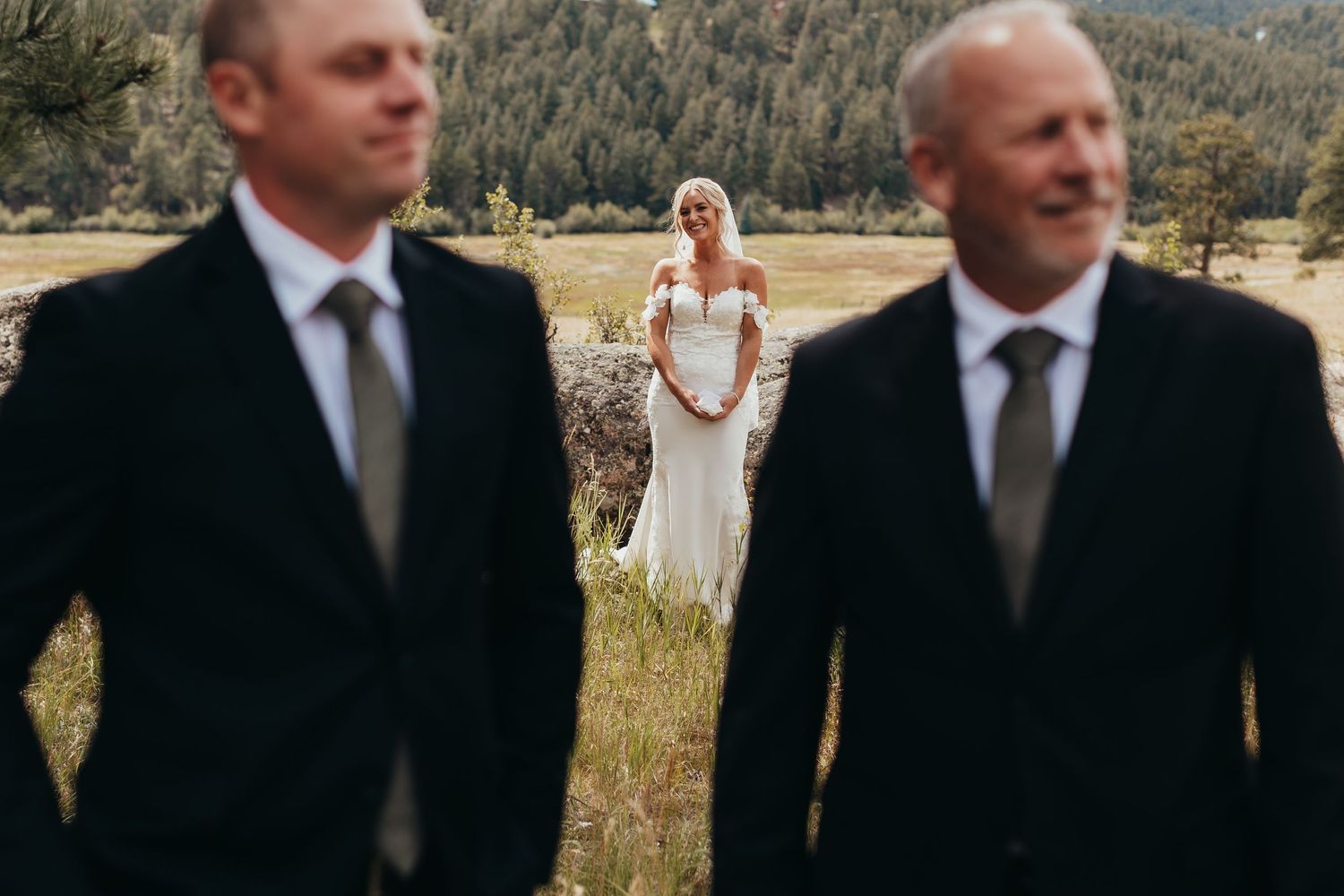 Artistic wedding photography composition in outdoor mountain setting.