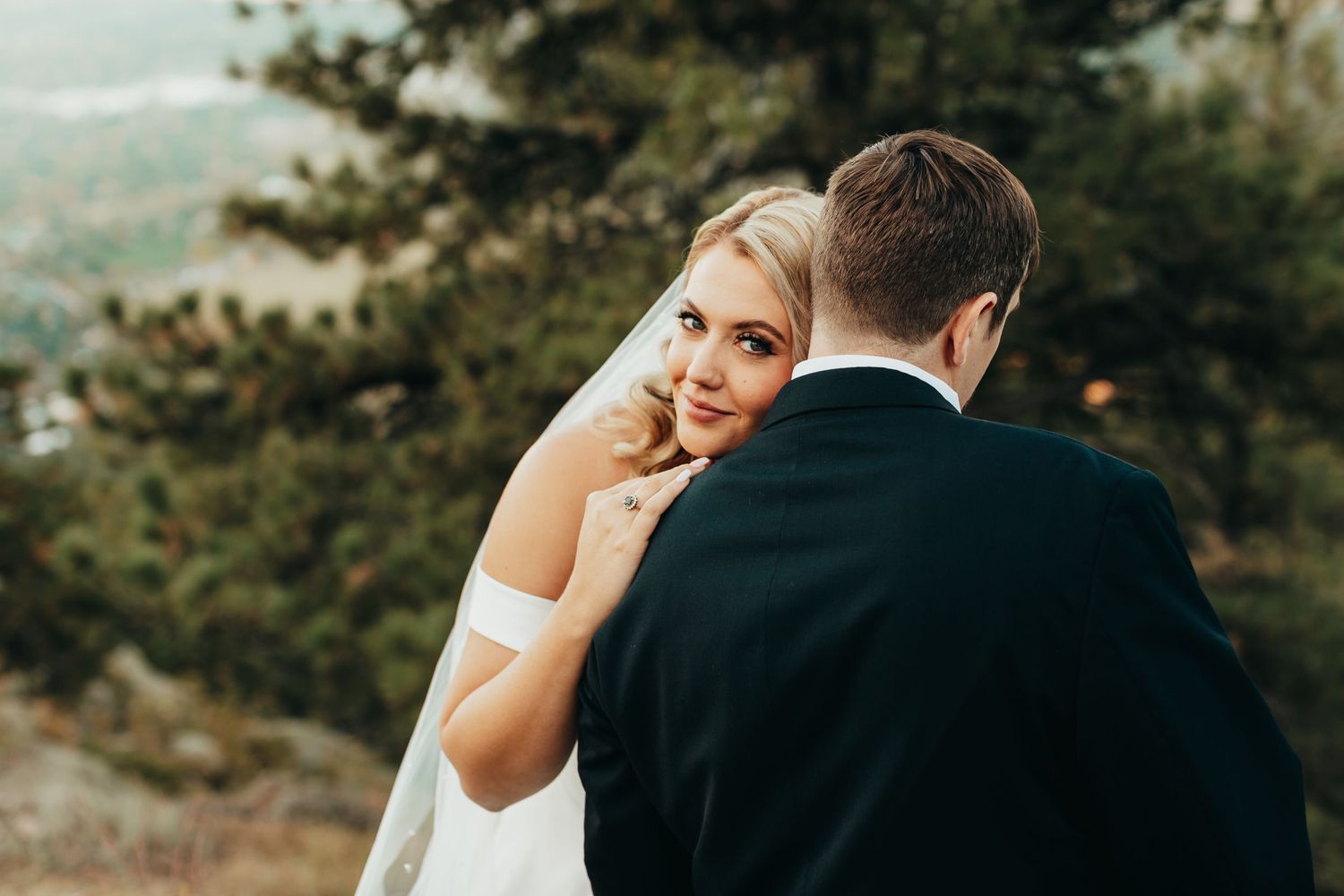 An intimate wedding moment captured on a mountain overlook.