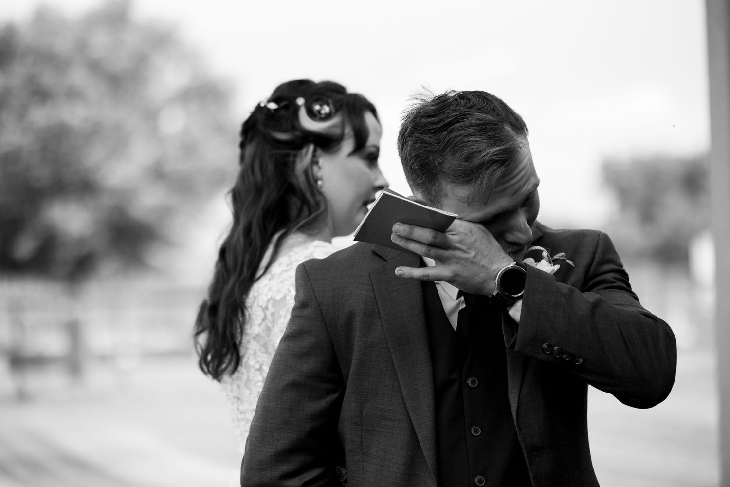 A romantic black and white moment between a dressed up couple.
