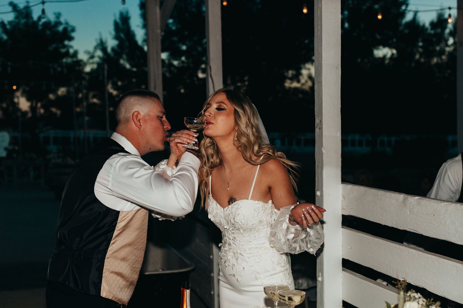 Newlyweds sharing drinks during their wedding reception.