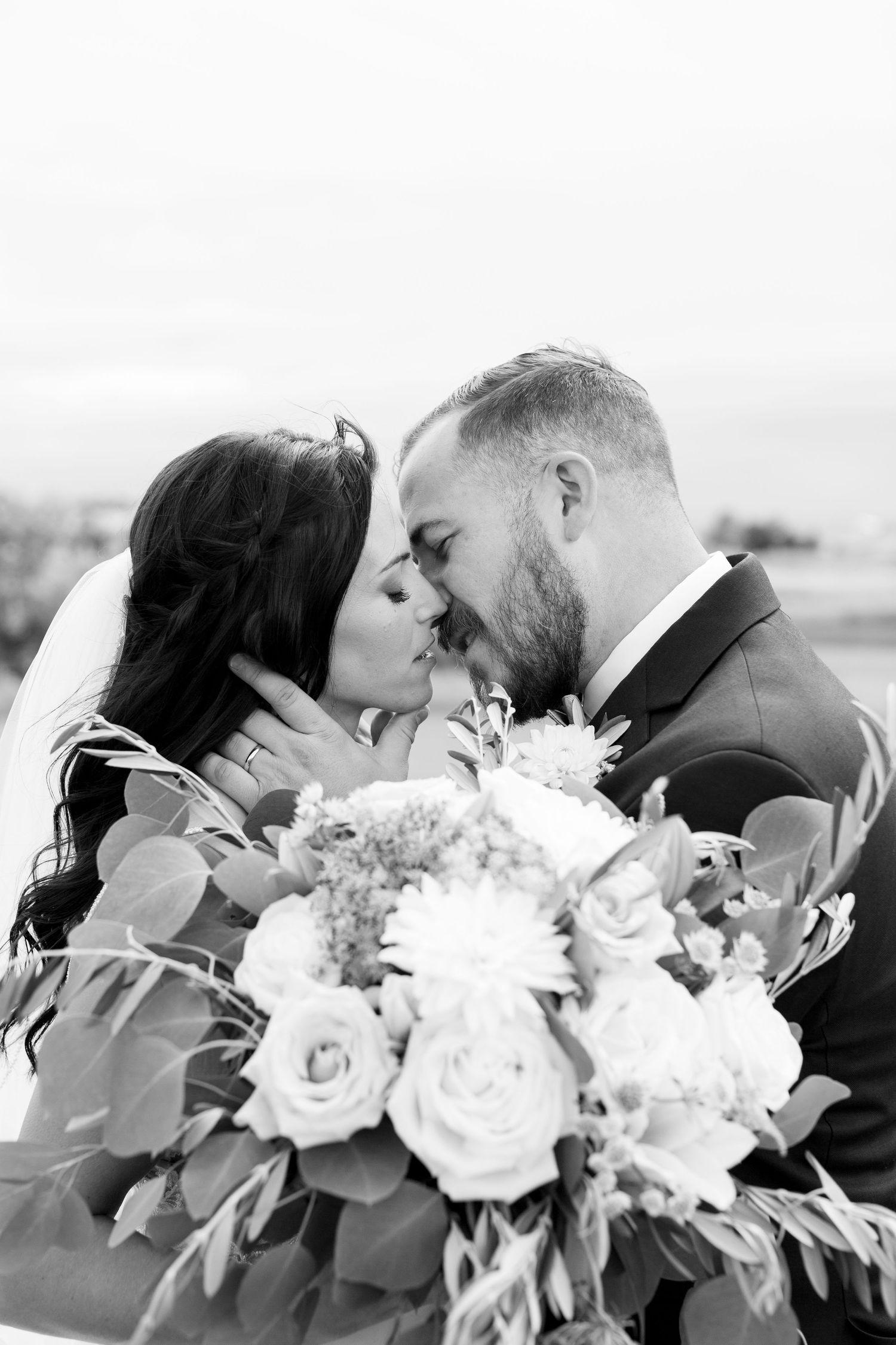 A romantic moment shared with a beautiful bouquet of roses and mixed flowers.