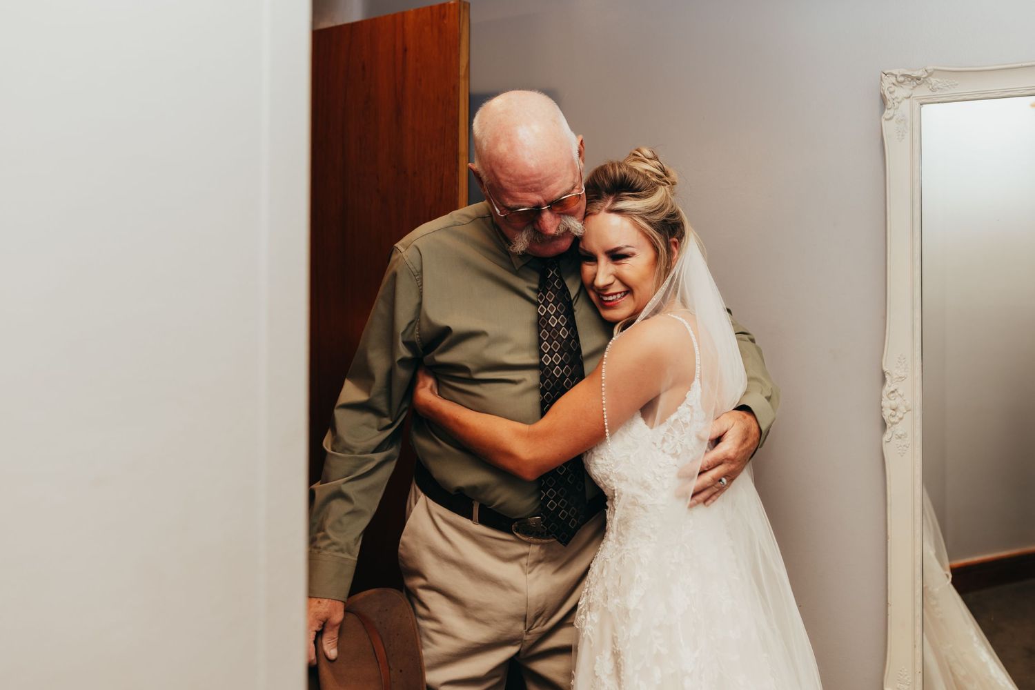Emotional moment captured in a private indoor setting during a wedding celebration.