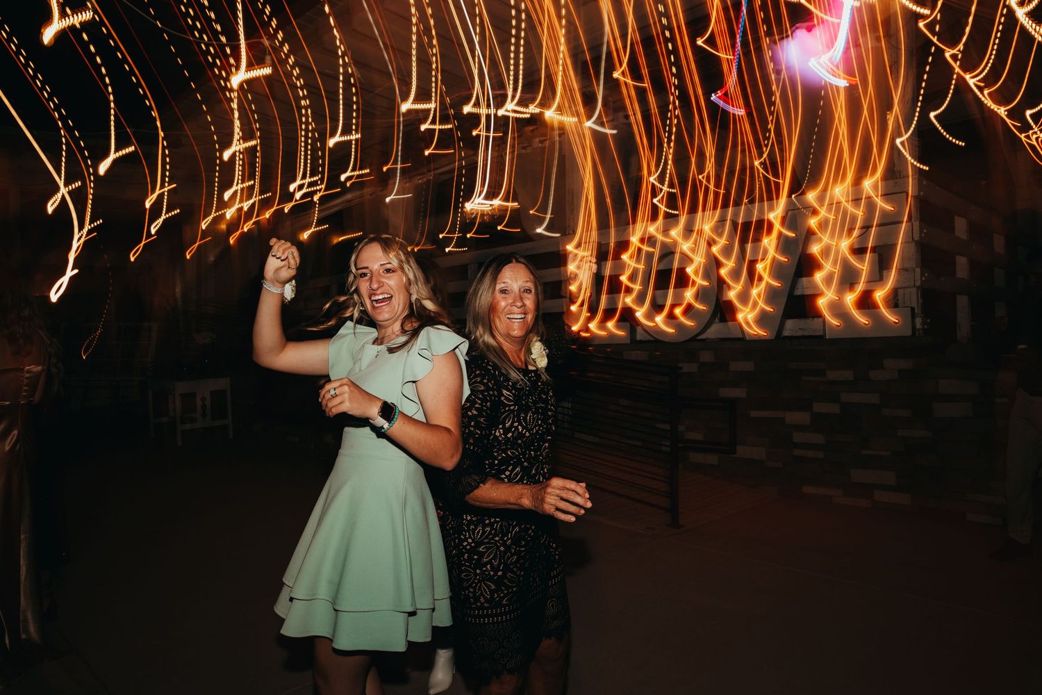 Dancing scene captured with beautiful light trails creating a magical motion effect in the background.