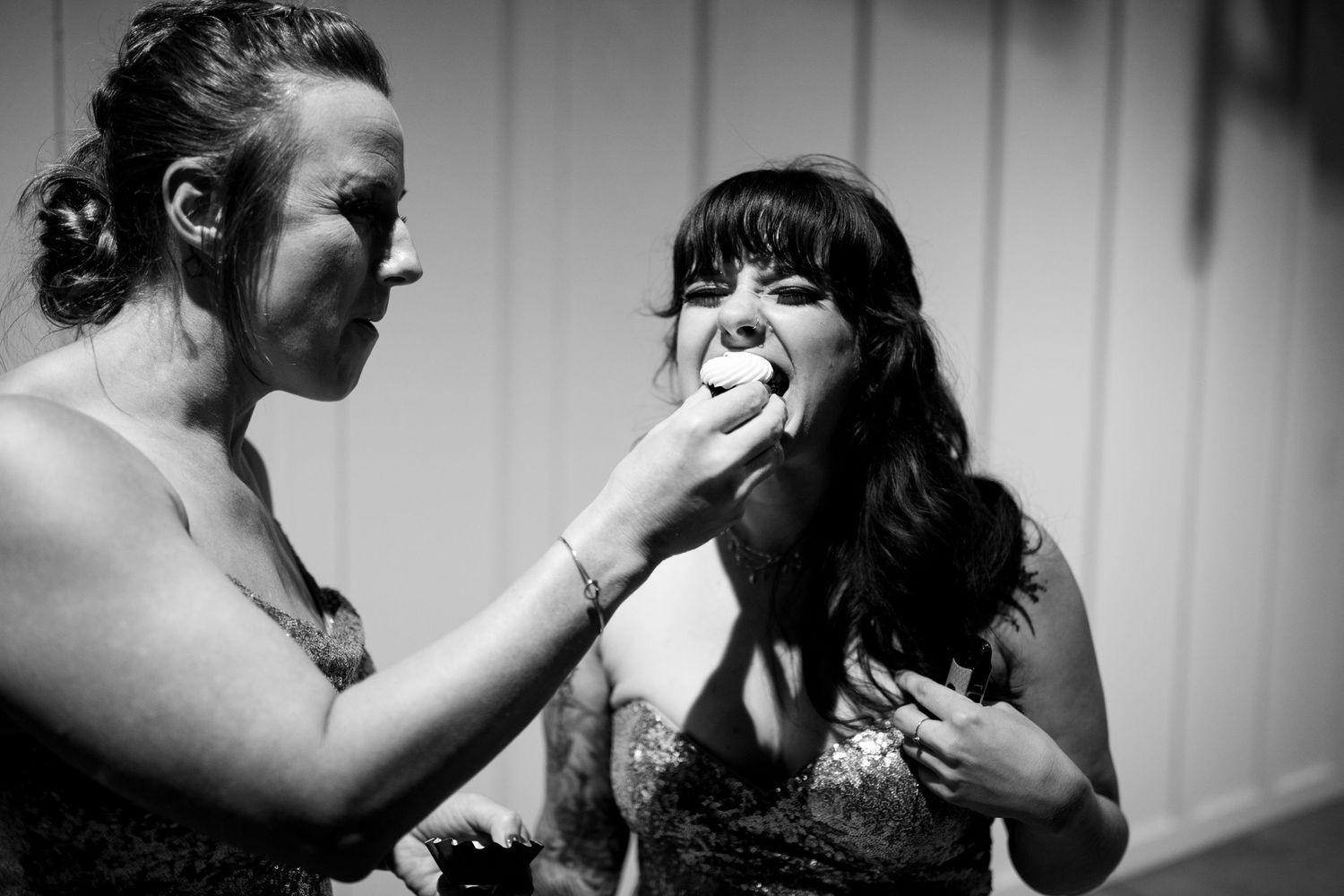 Two people share a candid moment in black and white photography.