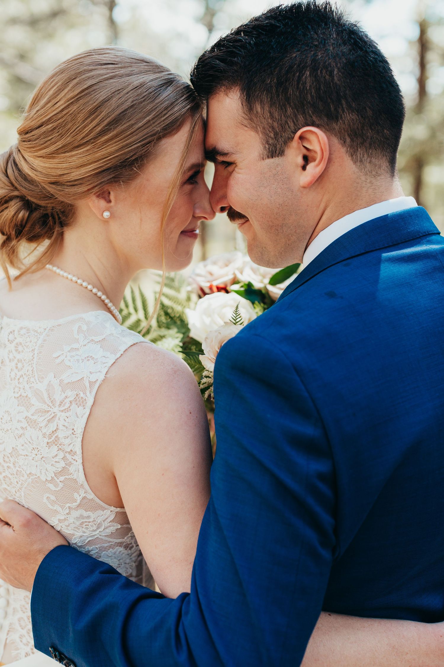 An intimate moment captured between newlyweds during their forest wedding ceremony.