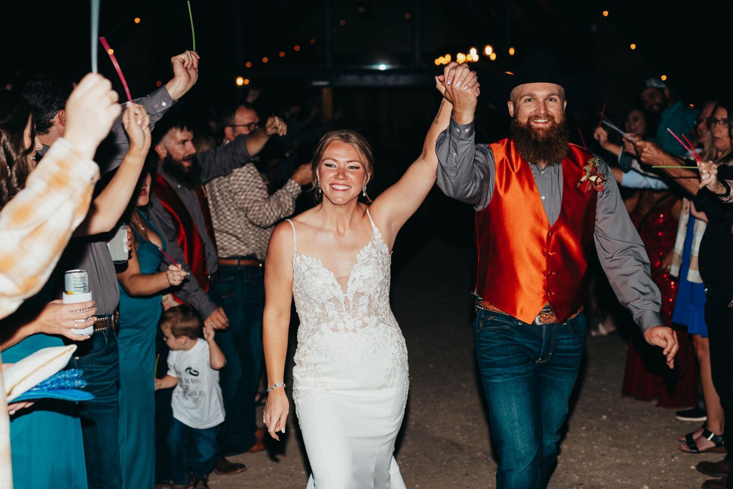 A joyful exit celebration with guests holding sparklers.