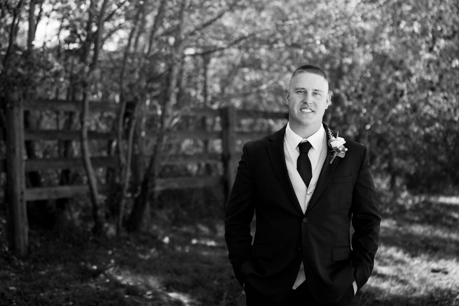 Classic black and white formal portrait in garden setting.