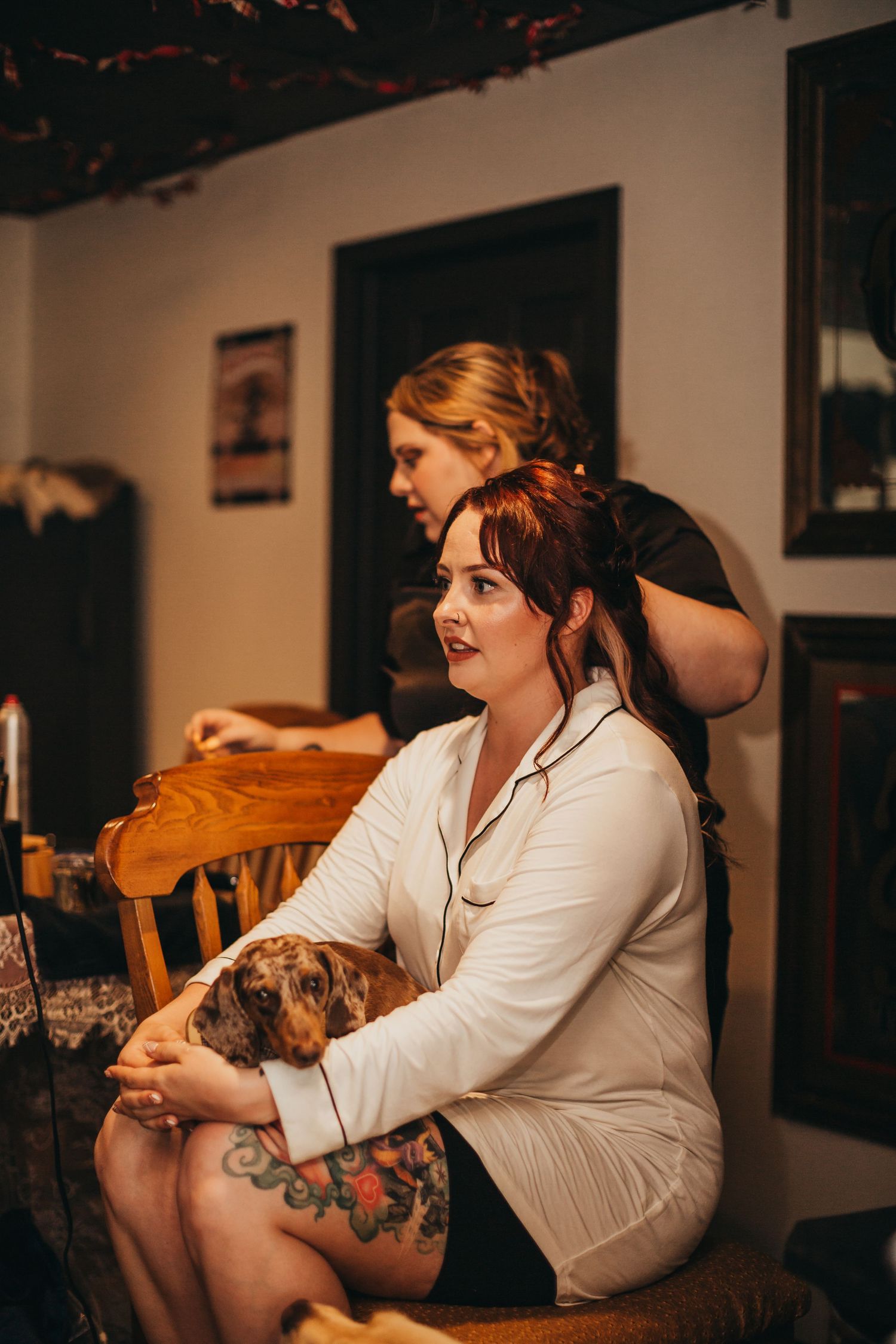 A quiet moment of preparation with a white robe and getting hair styled.