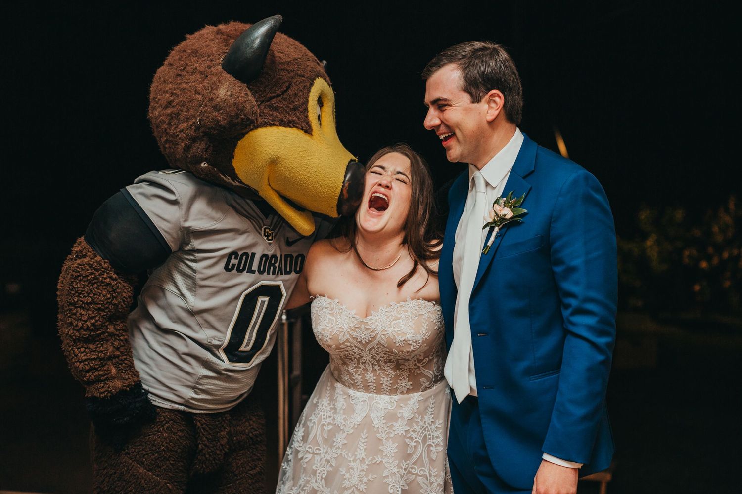 Fun moment with the Colorado Buffalo mascot interacting with wedding couple.
