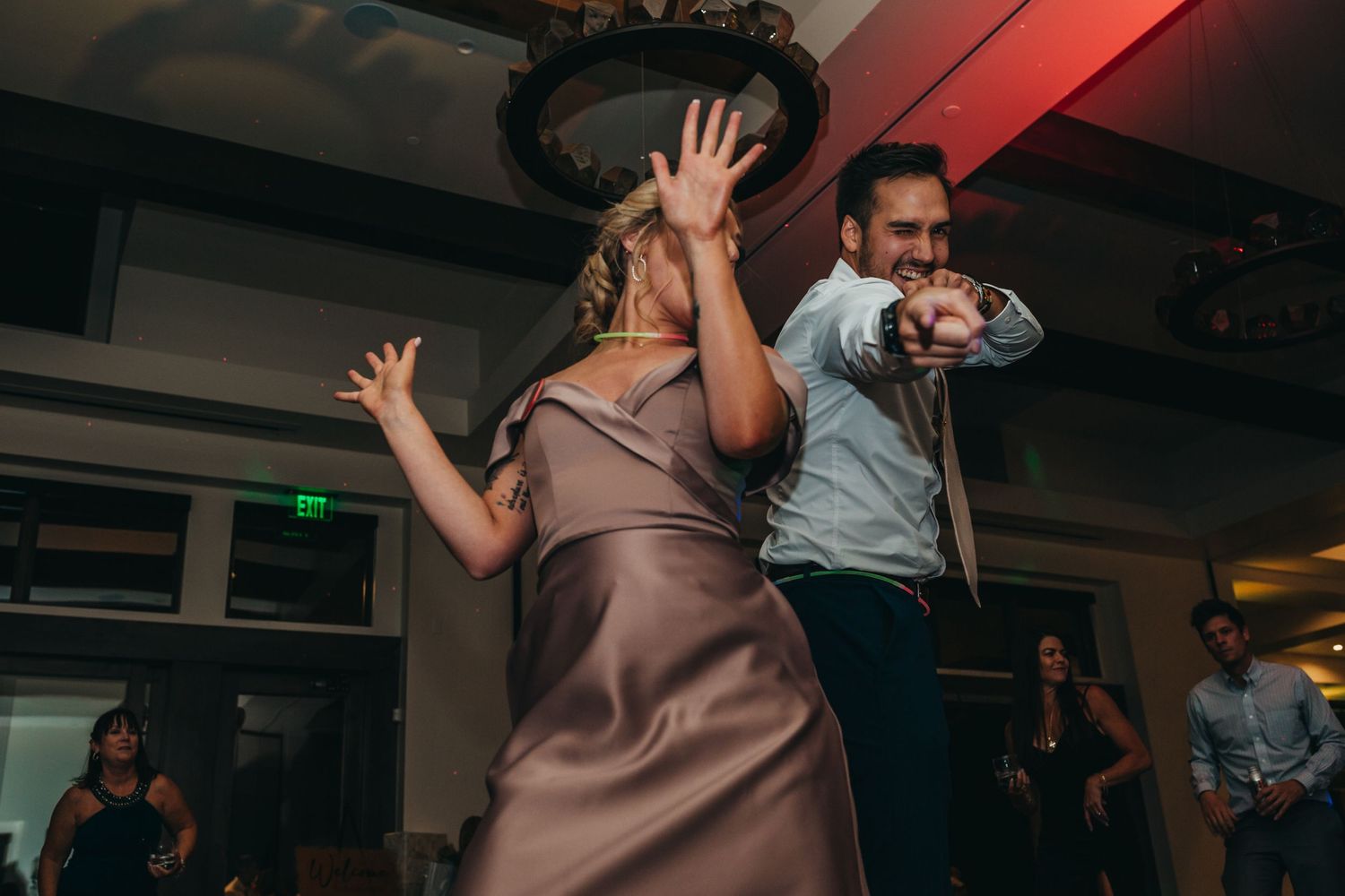 Dancing celebration at a wedding reception with guests in formal attire.