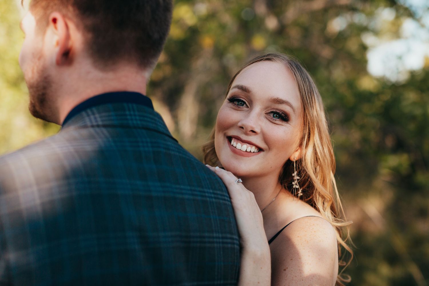 Romantic outdoor portrait capturing intimate moment between couple in natural lighting.