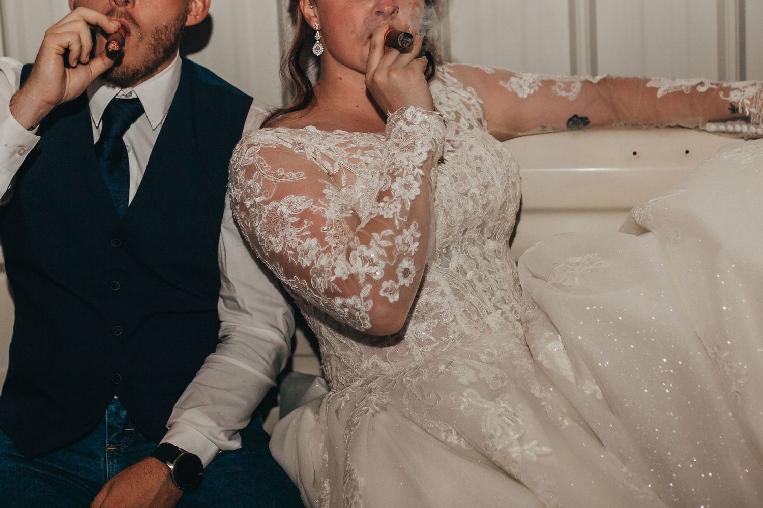 Close-up of newlyweds making silly faces during wedding celebrations.