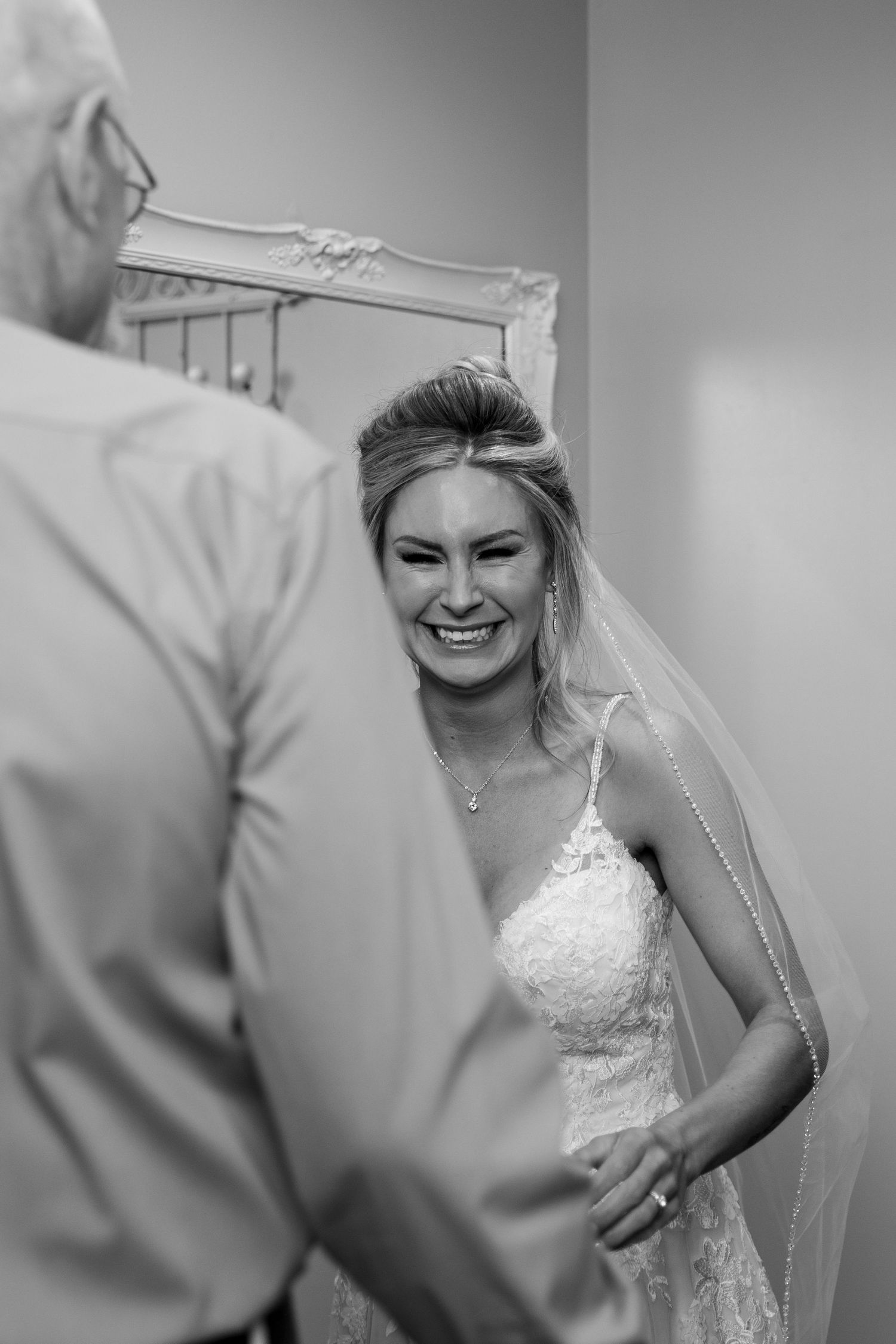 Black and white emotional candid moment during wedding preparations.