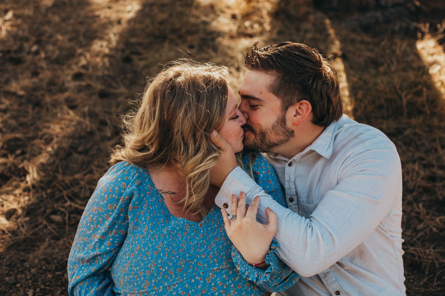 A couple sharing an intimate moment in golden sunlight.
