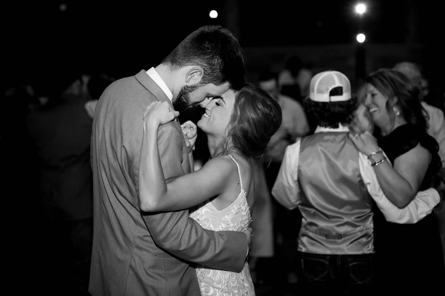Intimate black and white dance floor moment during wedding reception.