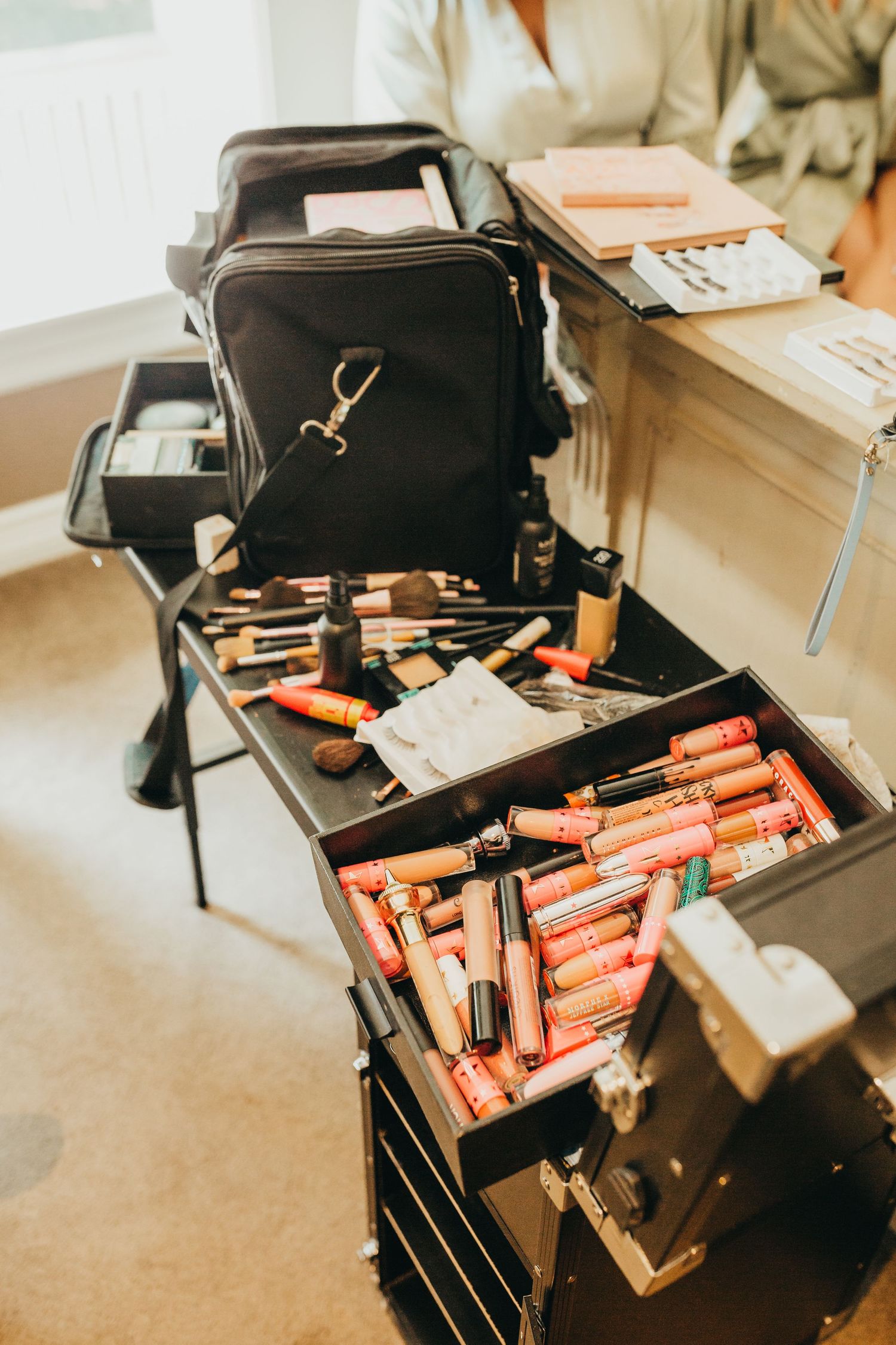 Professional makeup kit with brushes and cosmetics displayed in organized compartments.