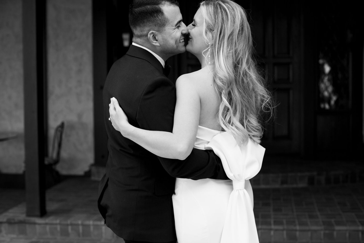 Romantic black and white portrait of newlyweds sharing an intimate moment.
