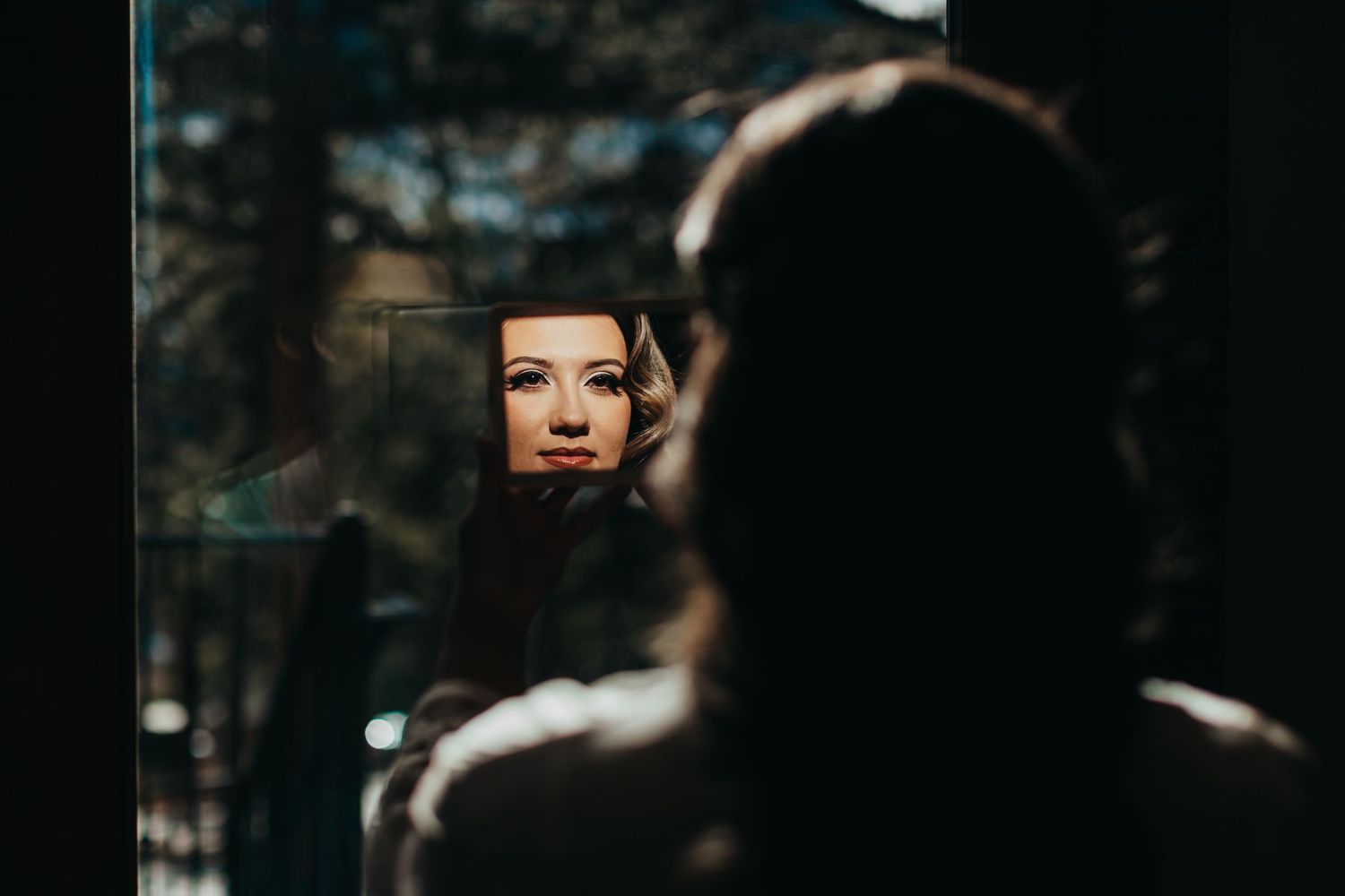 Creative mirror reflection shot capturing wedding day preparation details.