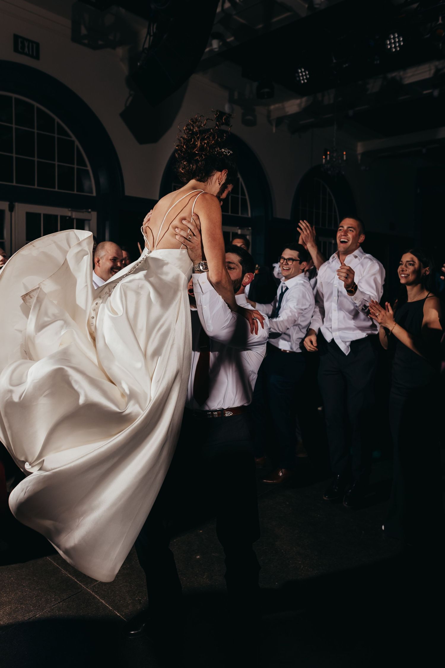 Wedding dress swirling during dramatic dance moment at reception.
