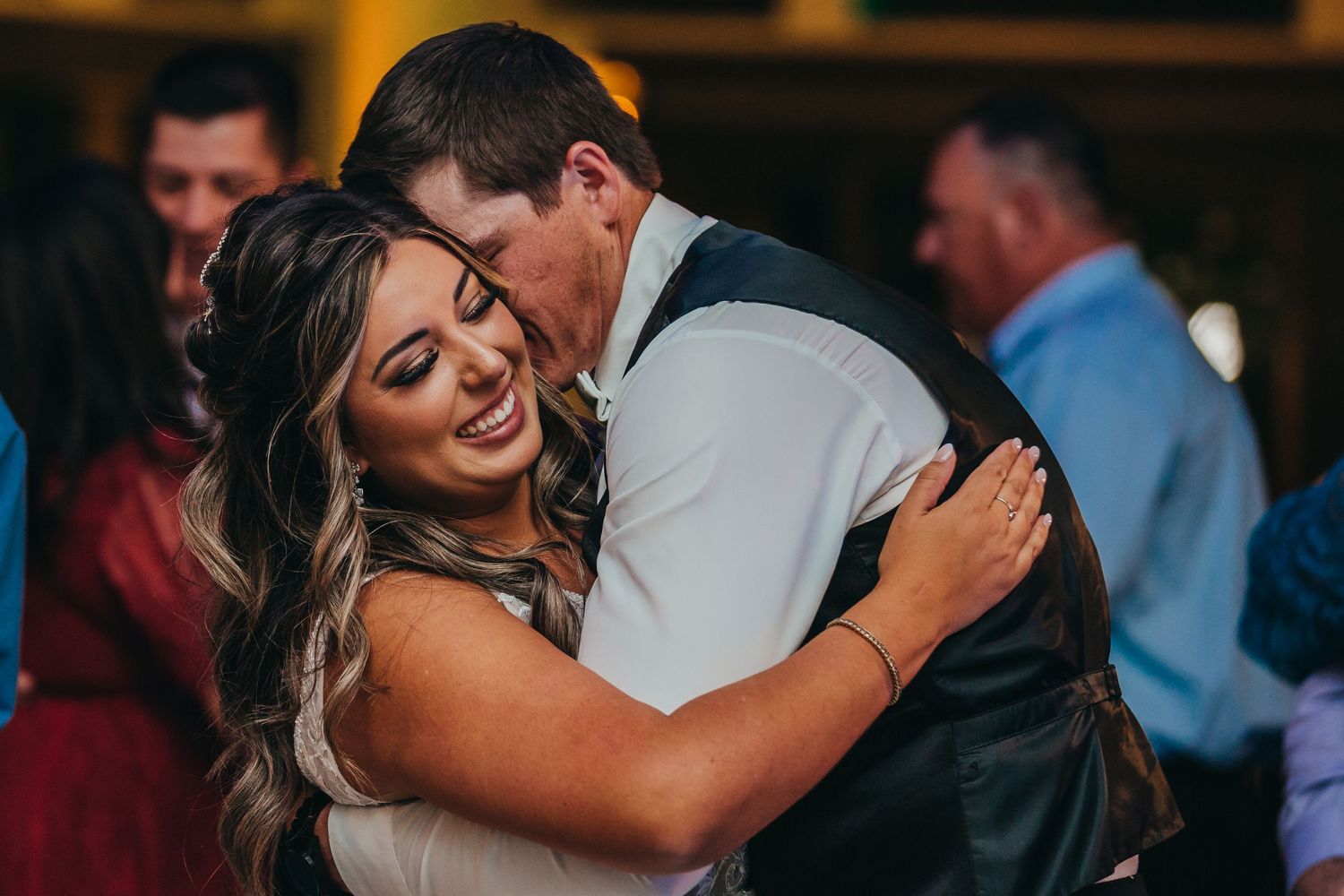 A romantic moment shared between a couple during their wedding reception dance.