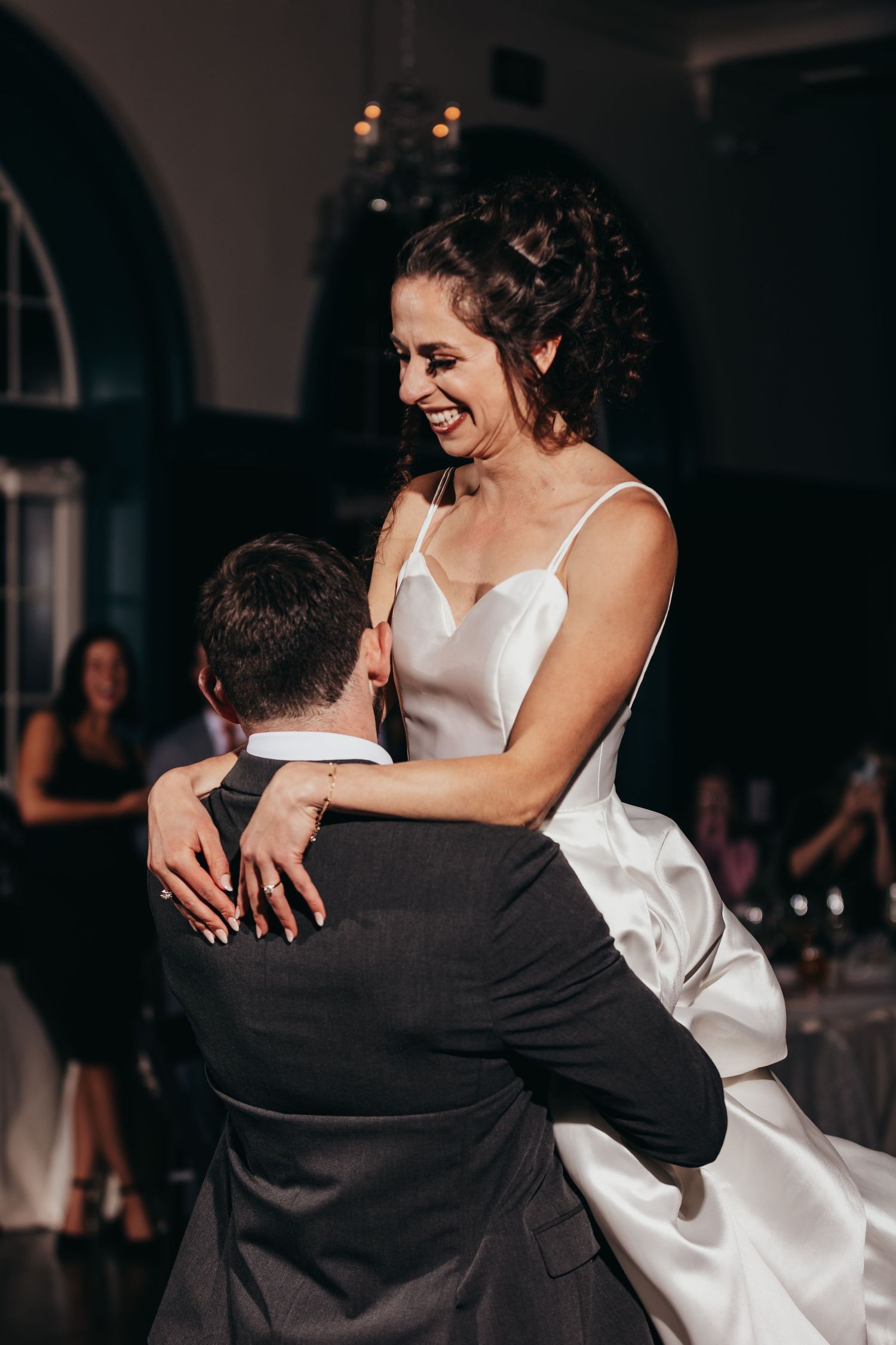 A couple shares an intimate dance moment at their wedding reception.