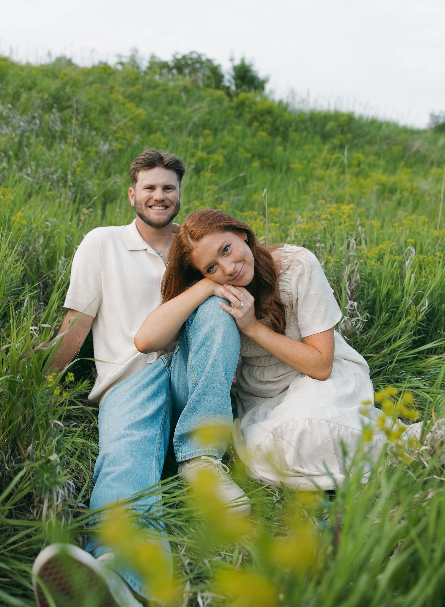 Romantic couple relaxing in a lush green meadow on a sunny day. Sioux Falls, South Dakota.