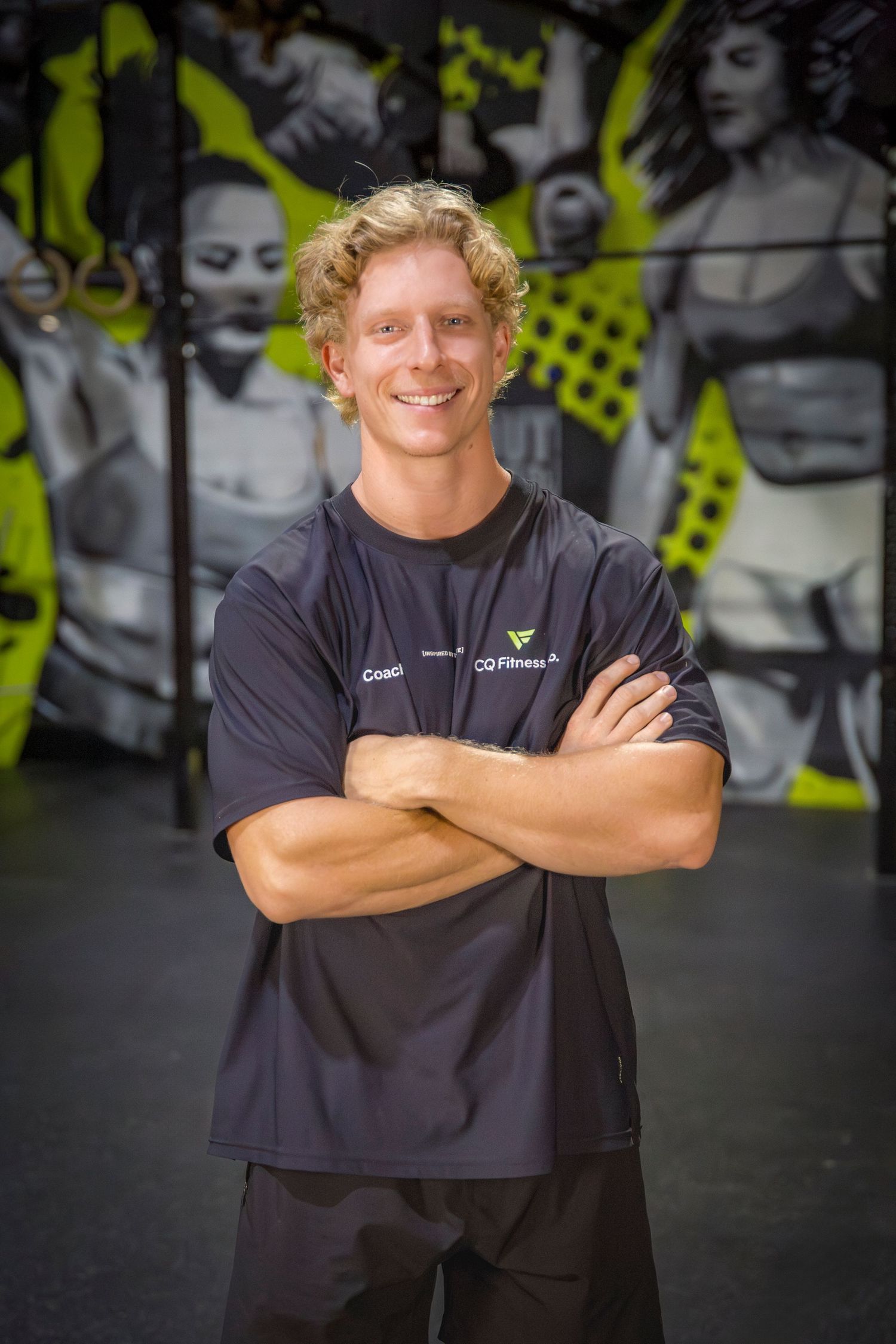 Gym coach headshots in front of gym mural at Rockhampton CrossFit location
