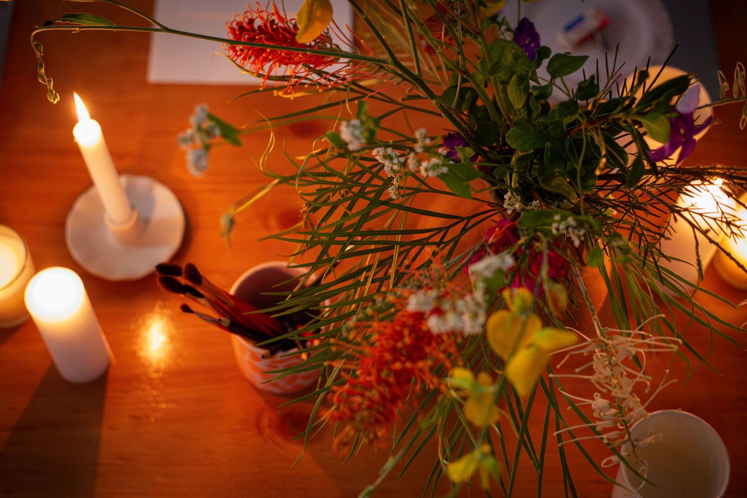 Colourful flower arrangement with moody lighting and candles during a branding shoot in Rockhampton