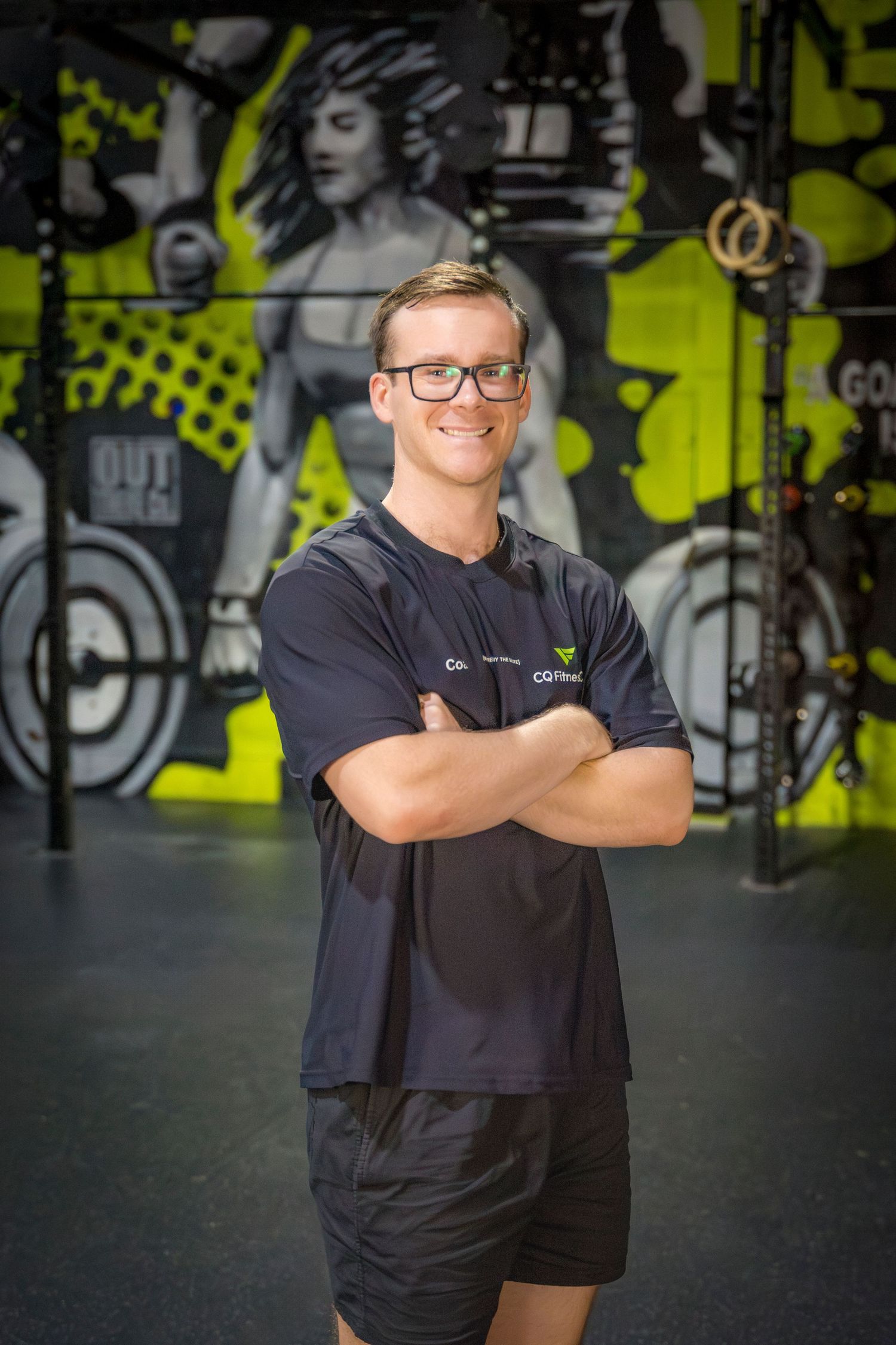 Gym coach headshots in front of gym mural at Rockhampton CrossFit location