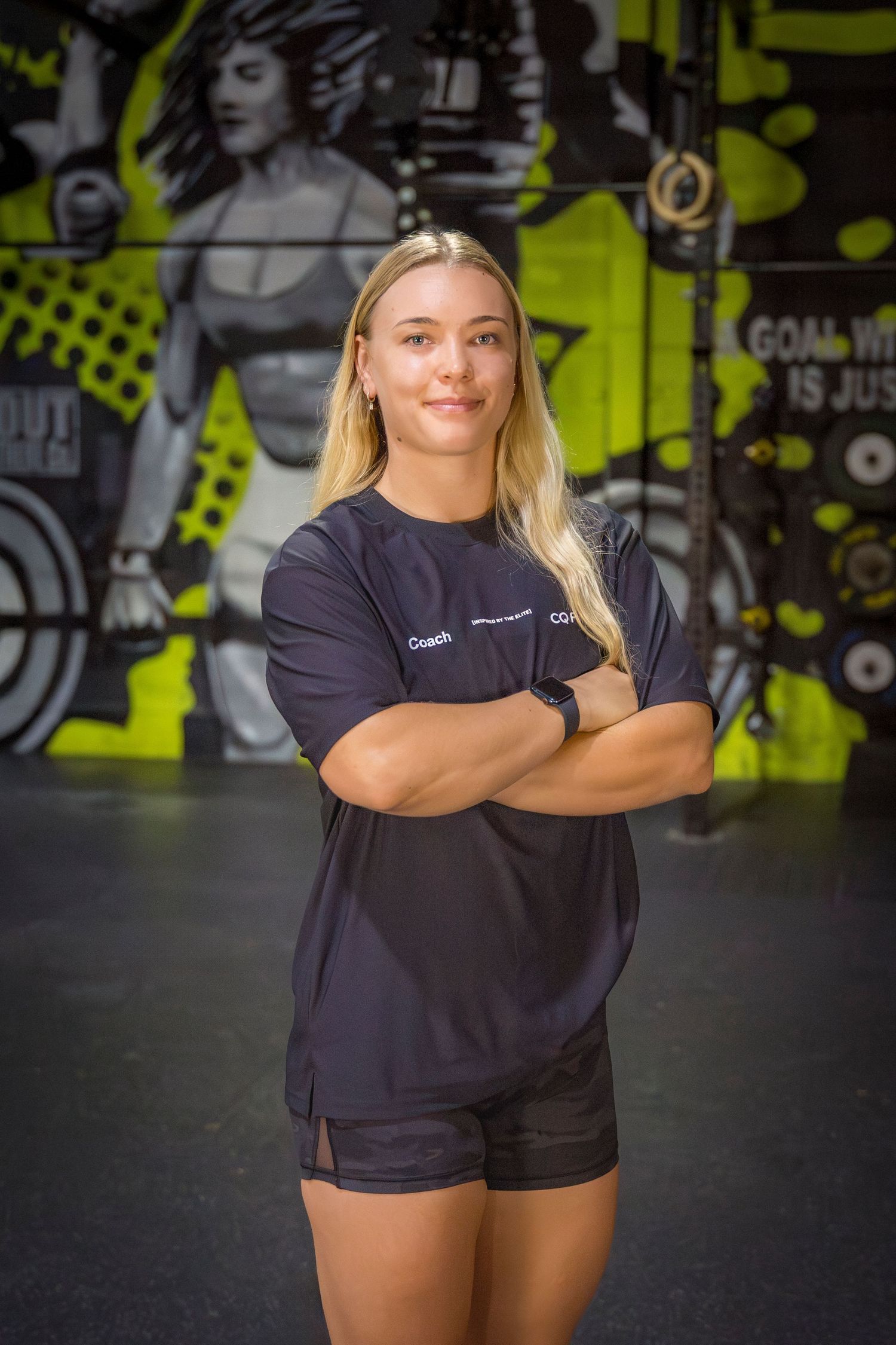 Gym coach headshots in front of gym mural at Rockhampton CrossFit location