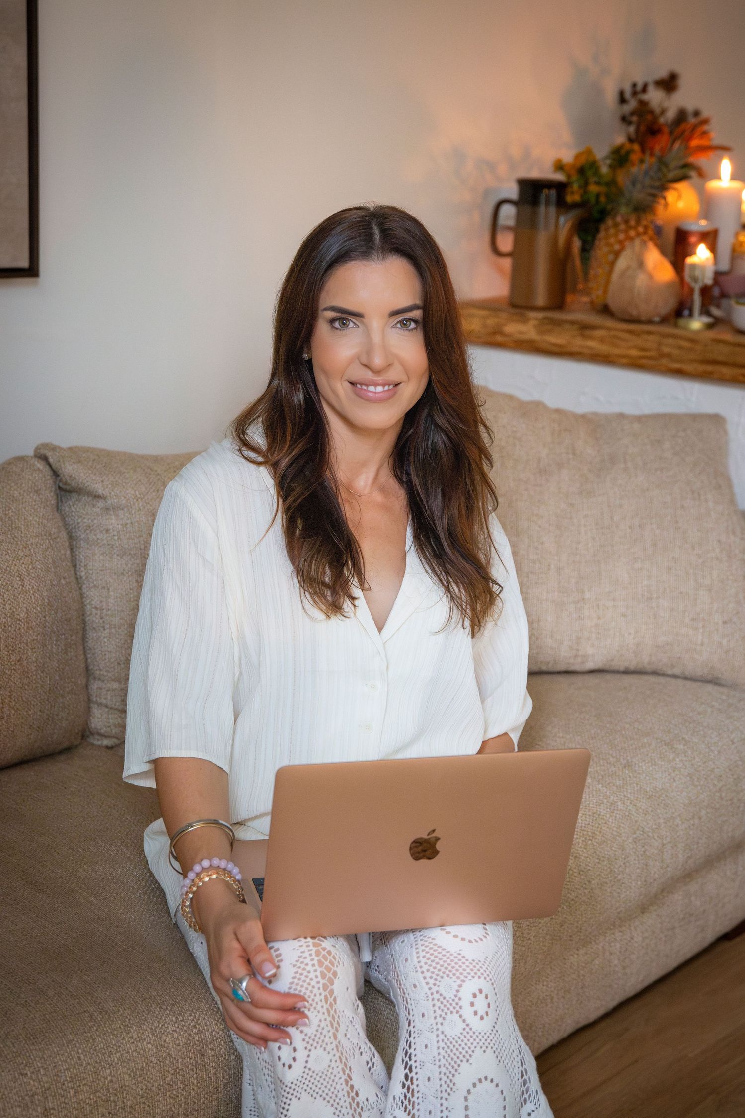 Natural light branding portrait of Yeppoon businesswoman seated on a couch with laptop