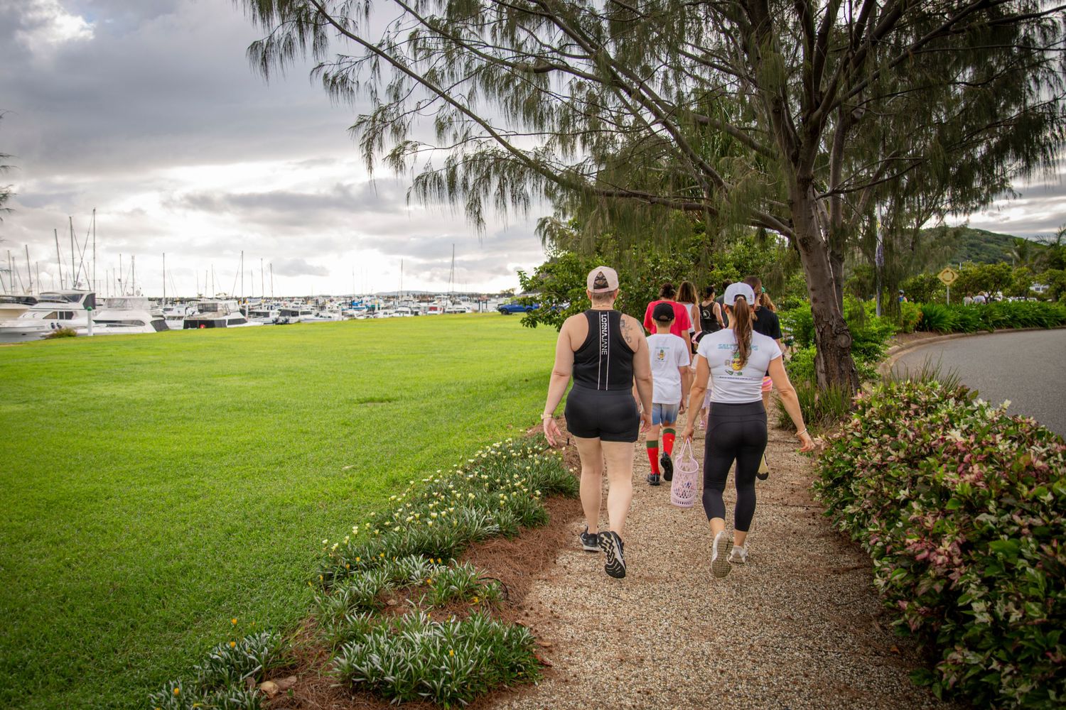 Group walking along scenic coastal path in Yeppoon