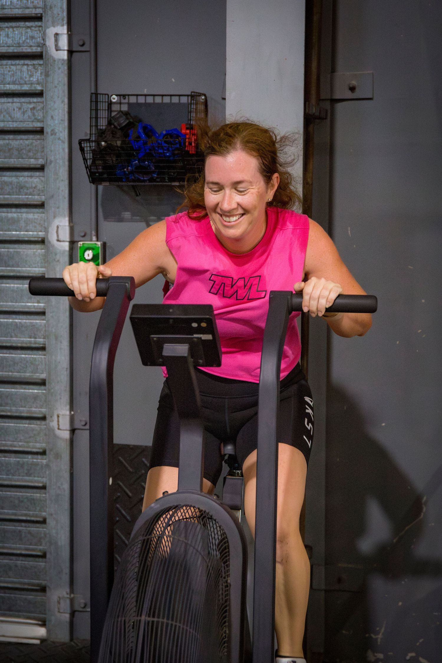 Gym member on bike at CQ Fitness Co during high-energy workout