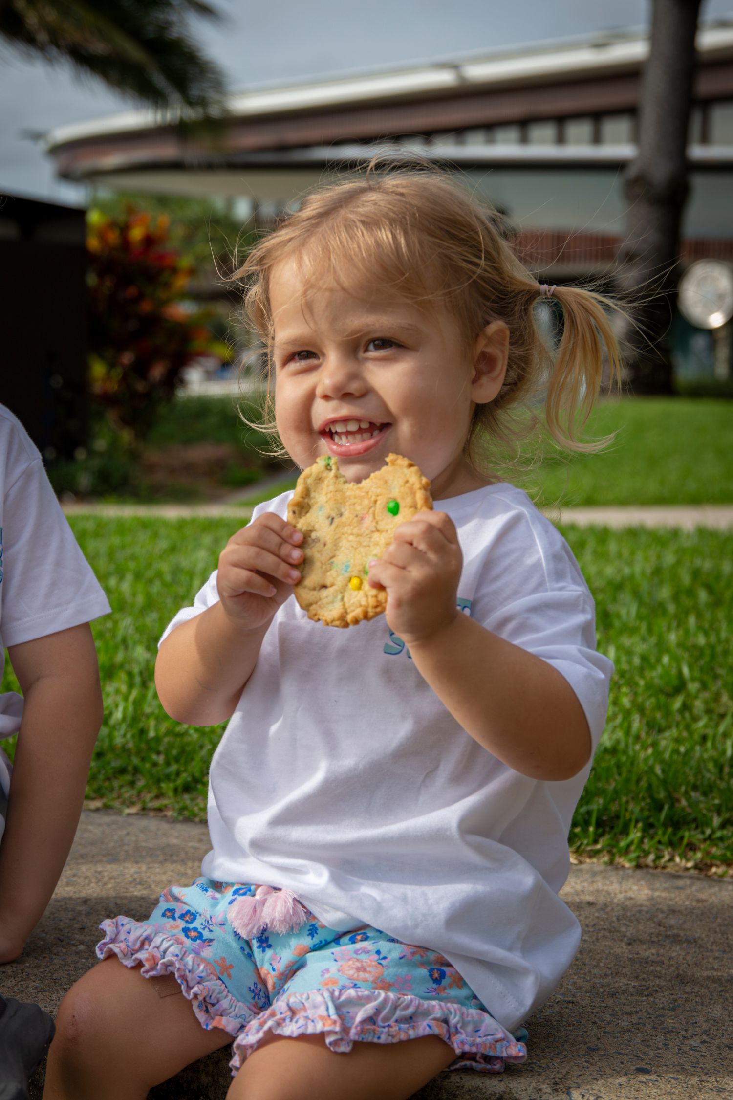 Child at outdoor event in Yeppoon eating a cookie