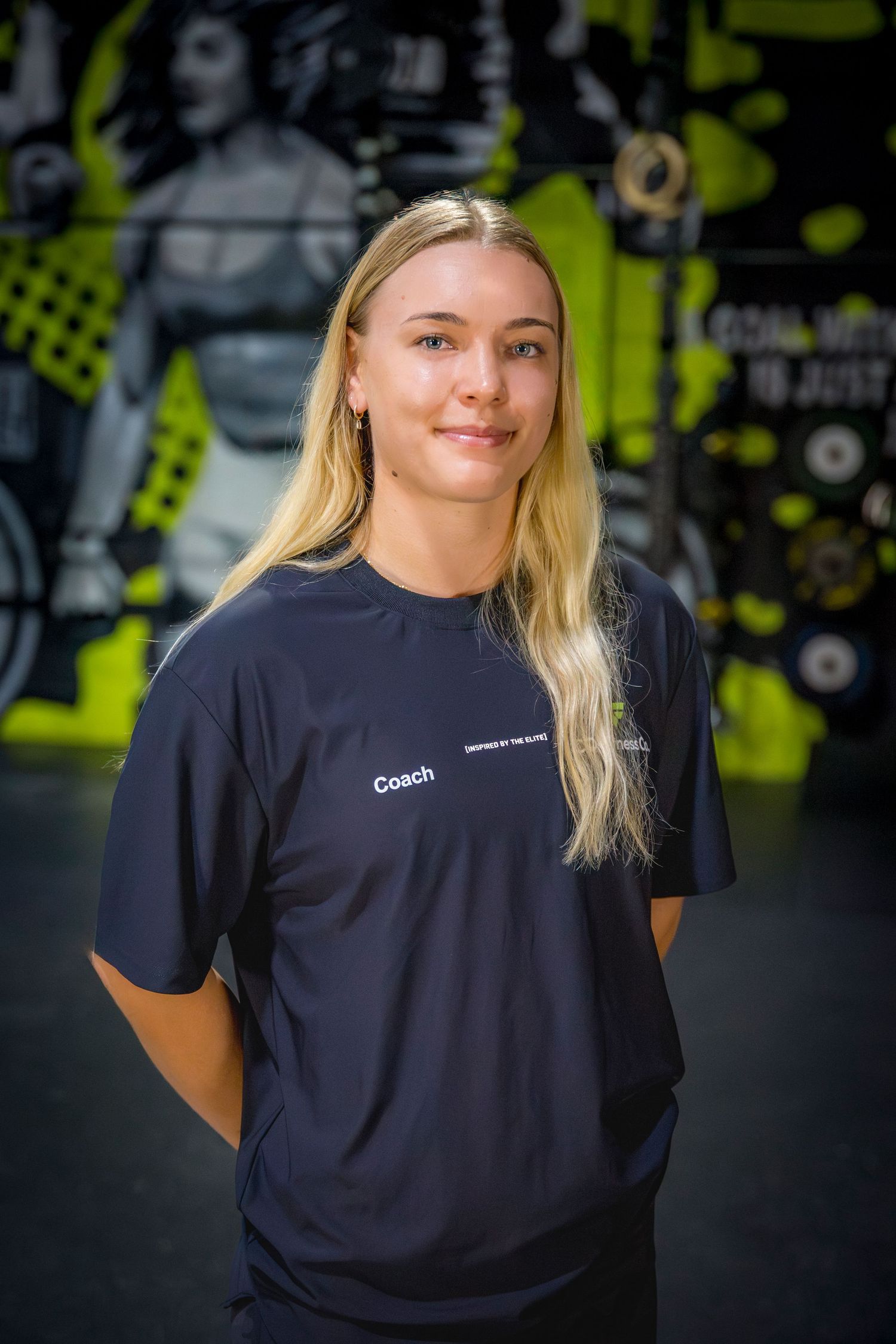 Gym coach headshots in front of gym mural at Rockhampton CrossFit location