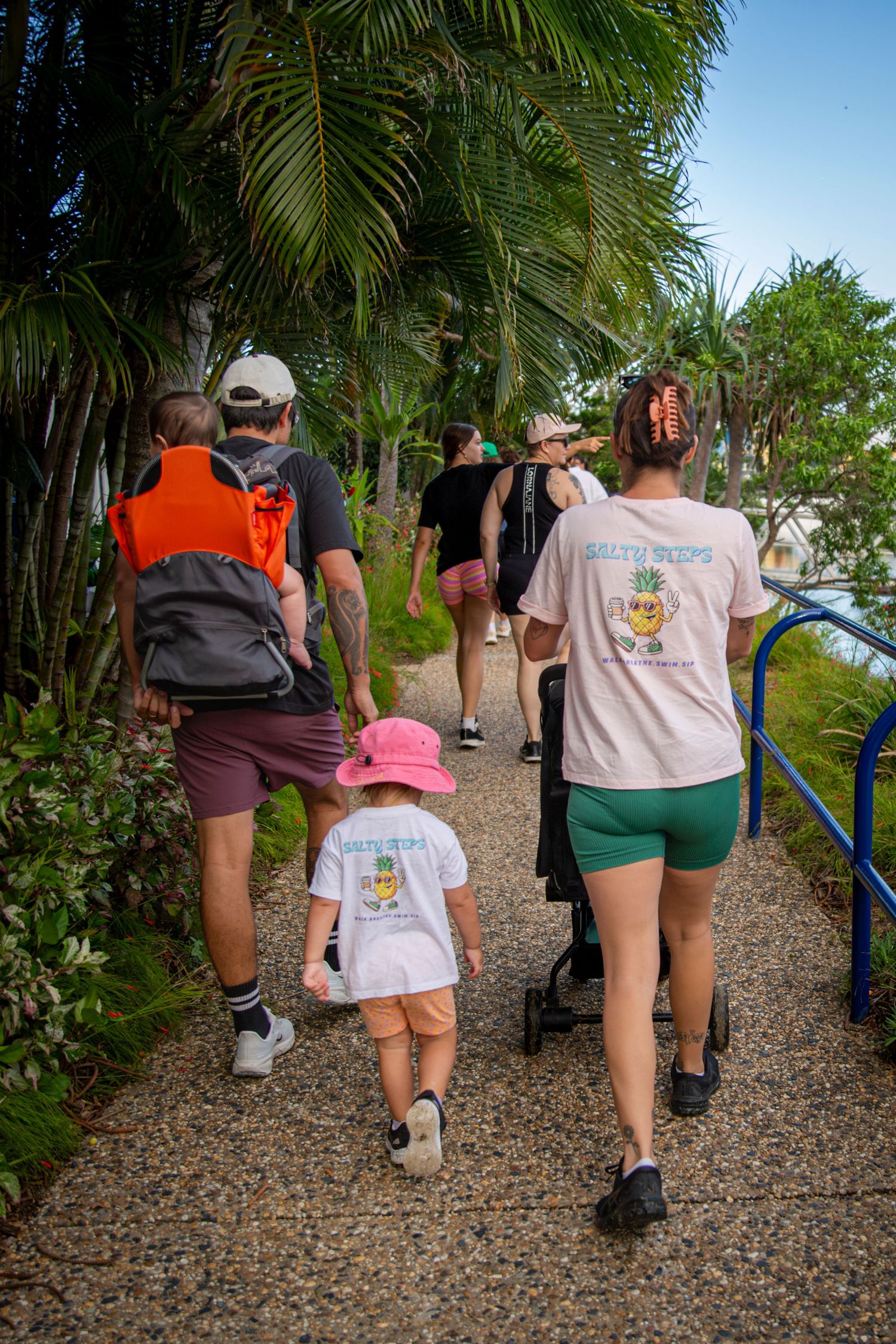 Group walking along scenic coastal path in yeppoon at community event
